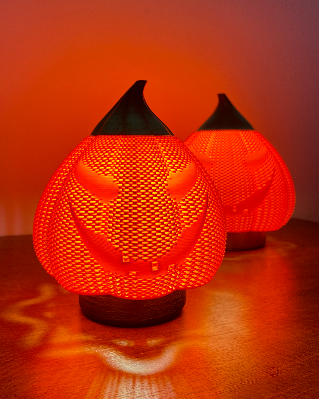 a couple of lamps sitting on top of a wooden table