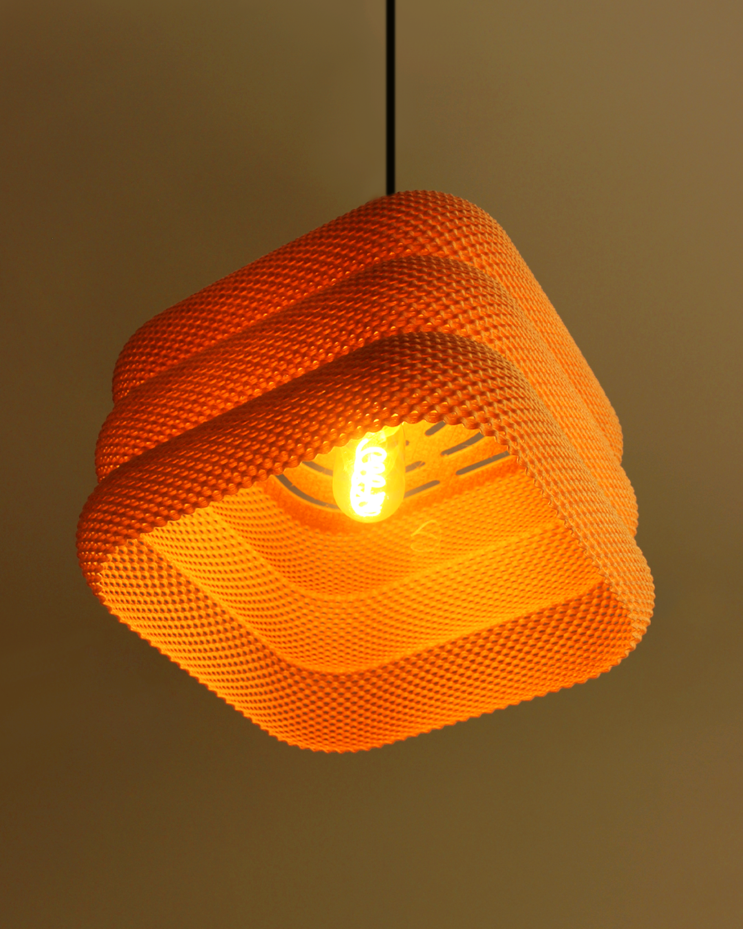 a yellow light hanging from a ceiling in a room