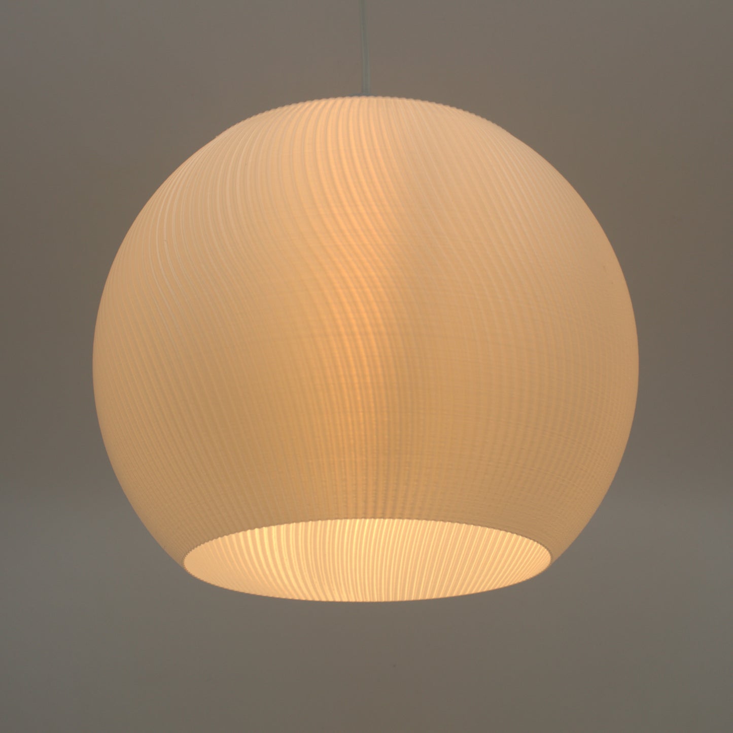 a white light hanging from a ceiling in a room