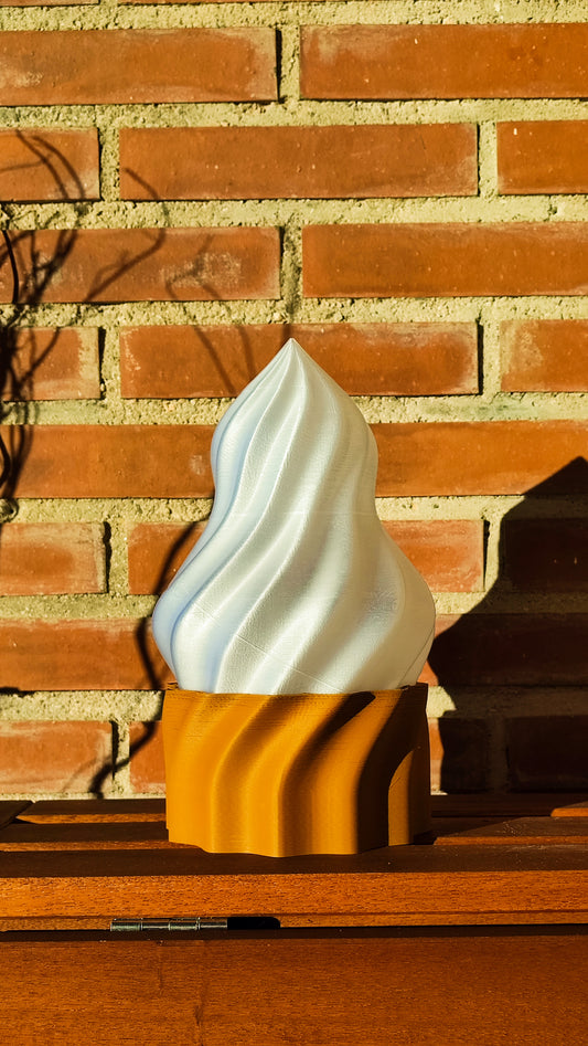 a yellow and white vase sitting on top of a wooden table