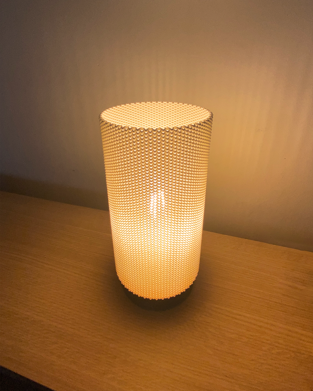 a lit candle sitting on top of a wooden table