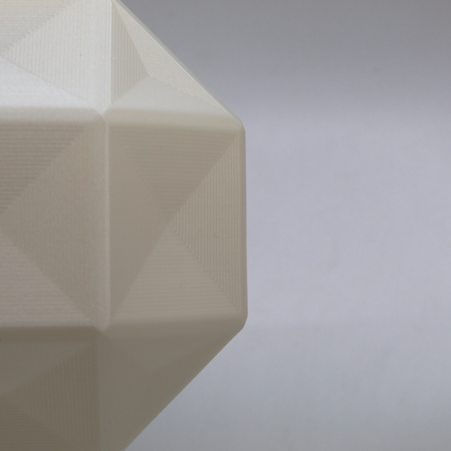 a white vase sitting on top of a table