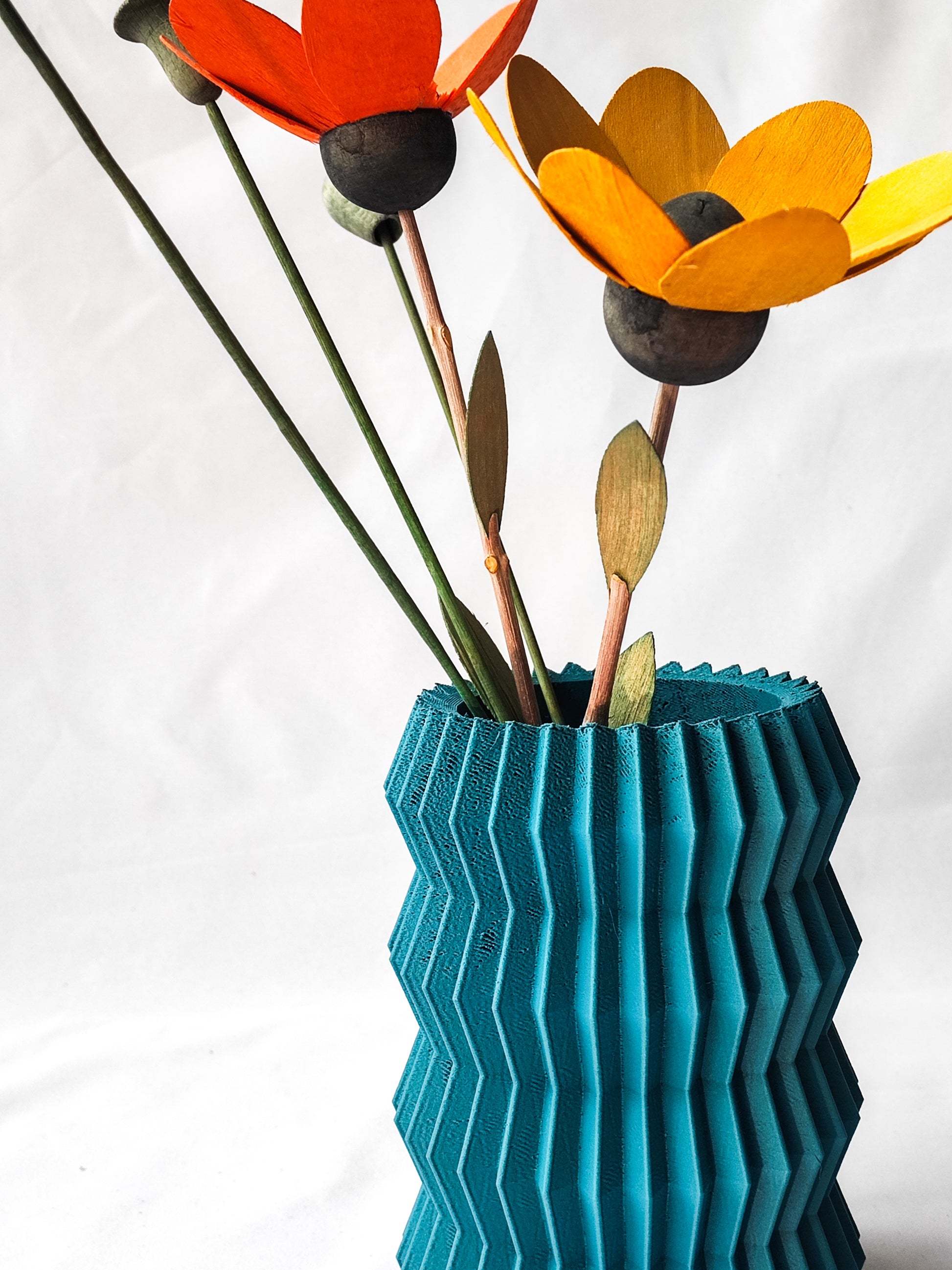 a blue vase with three flowers in it