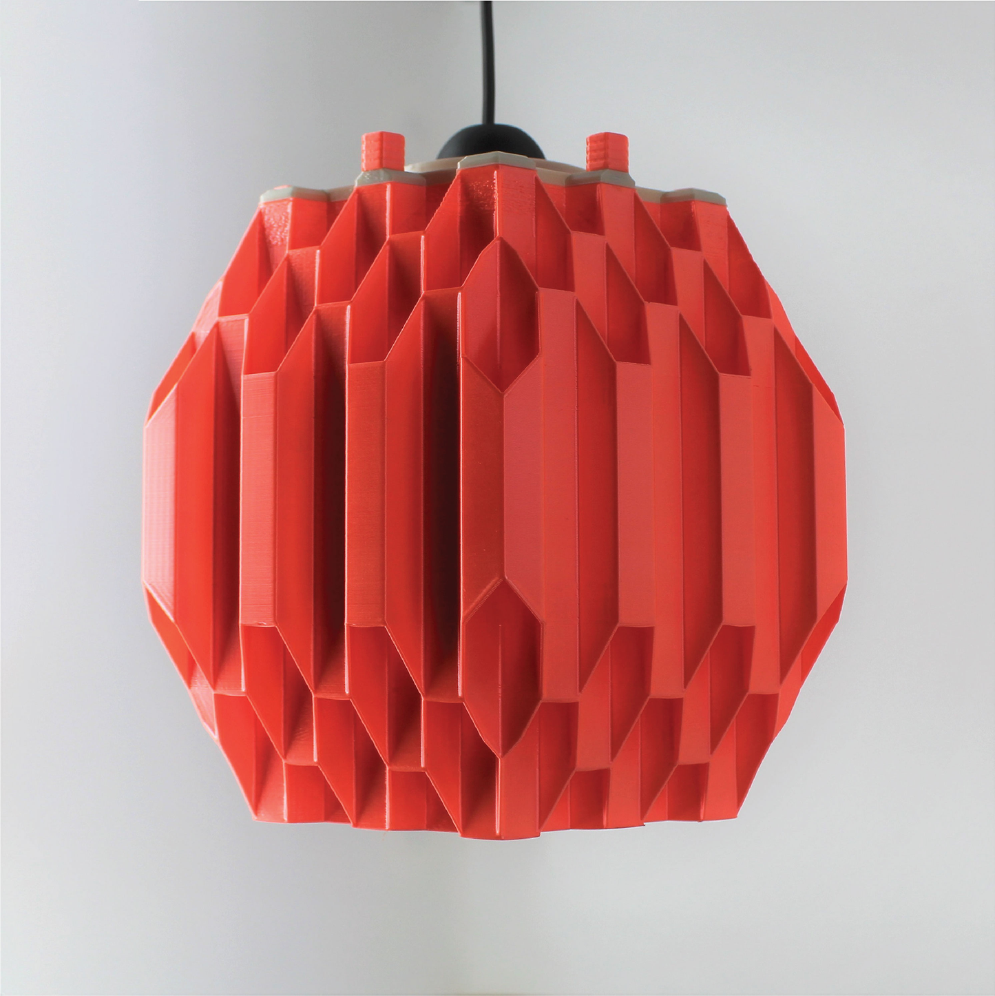 a red light fixture hanging from a ceiling