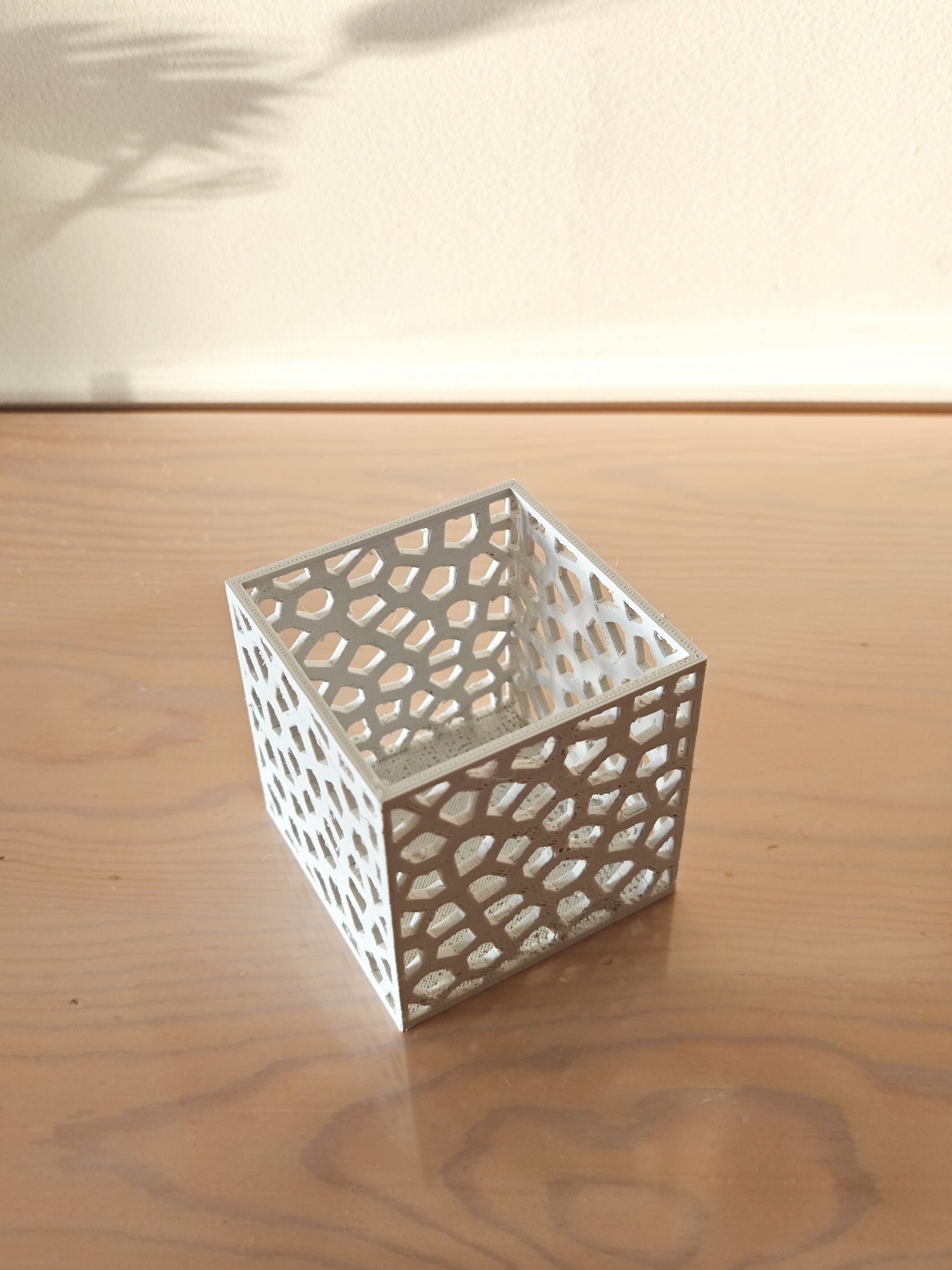 a small white box sitting on top of a wooden table