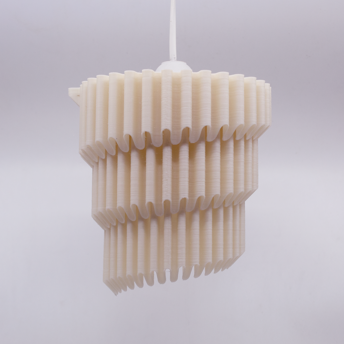 a white light fixture hanging from a ceiling