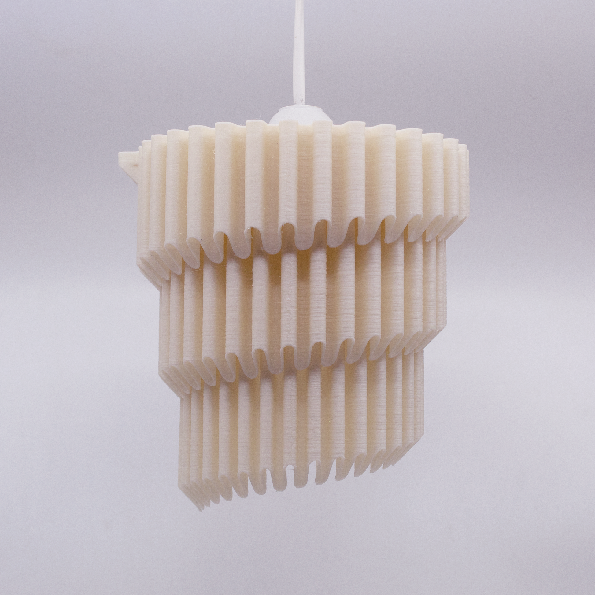 a white light fixture hanging from a ceiling