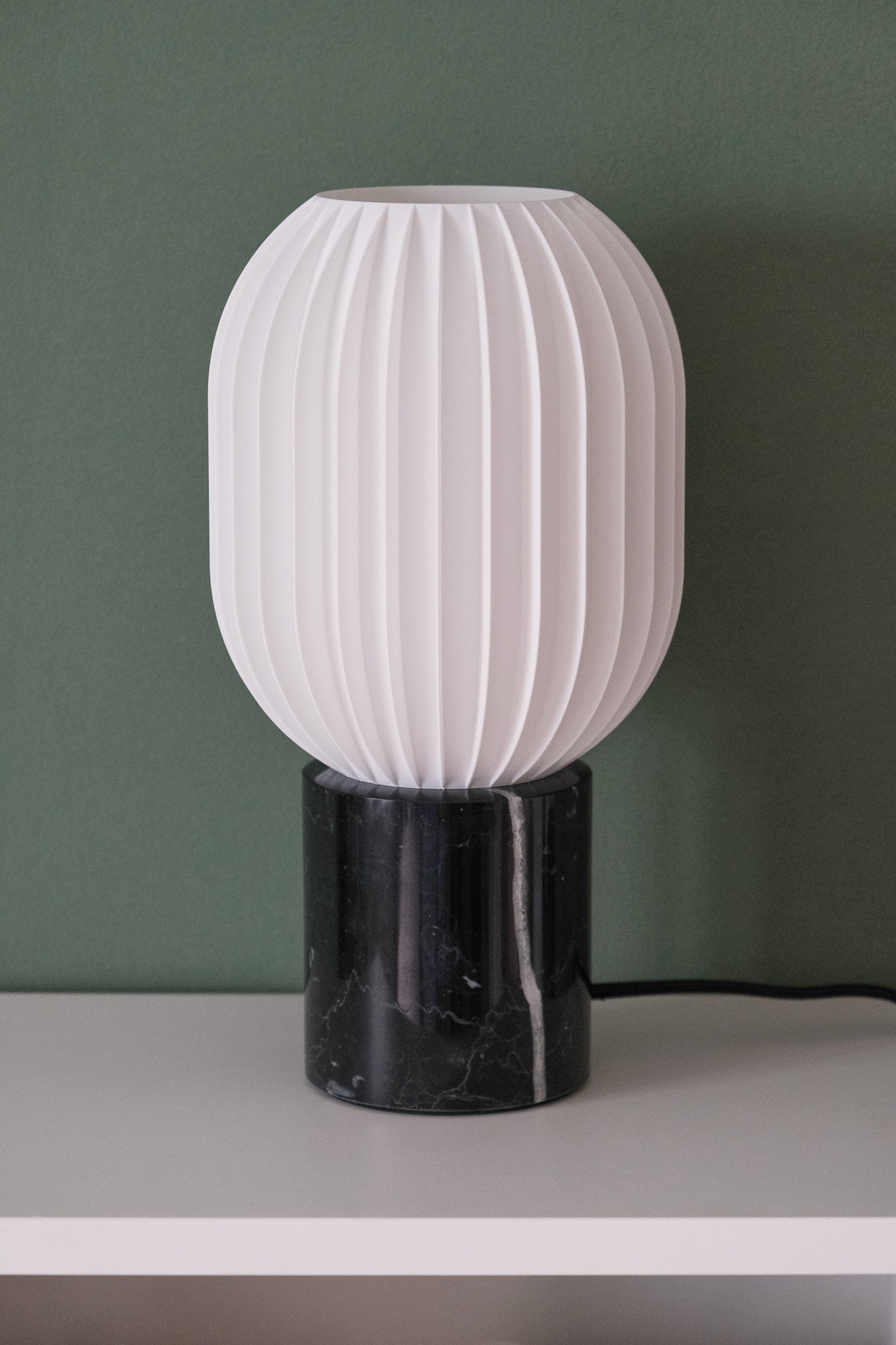 a black and white lamp sitting on top of a table