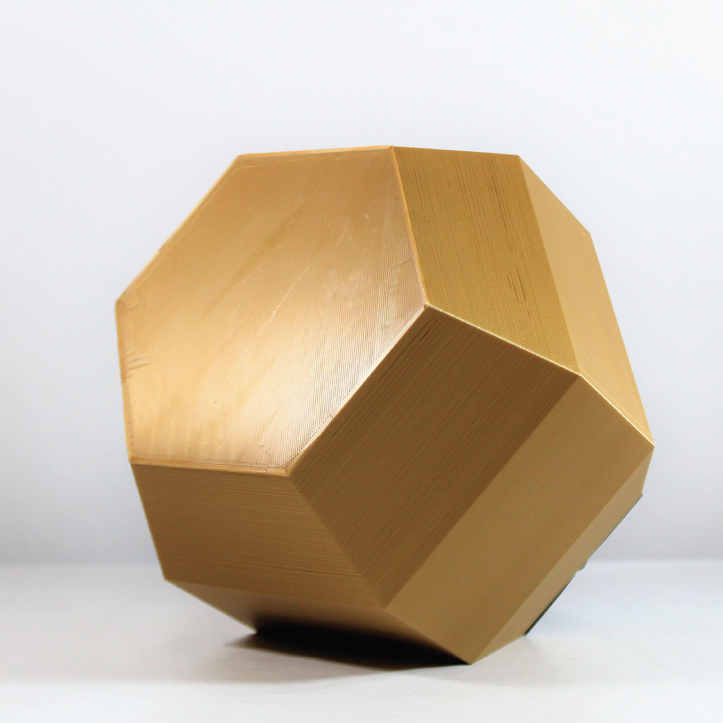 a wooden object sitting on top of a white table