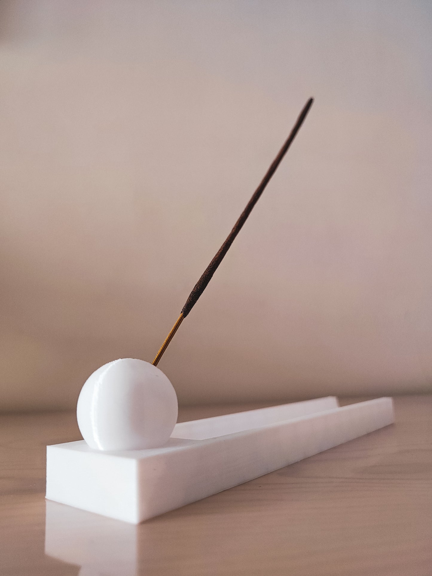 a white object with a stick sticking out of it