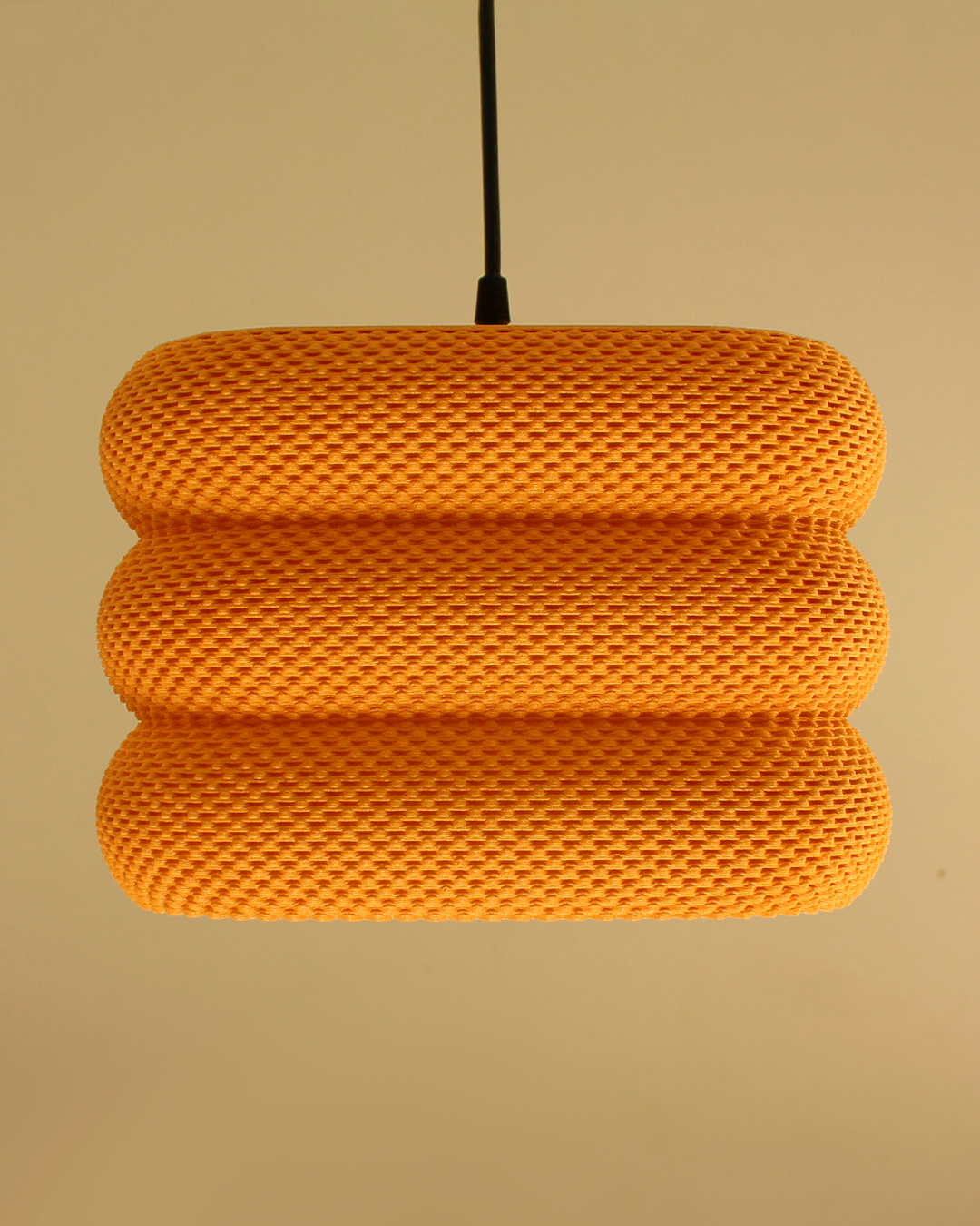 a yellow light fixture hanging from a ceiling
