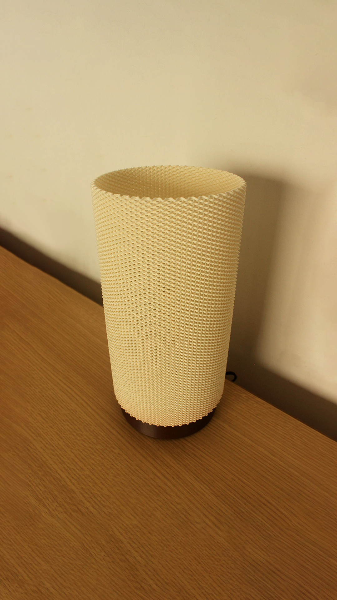 a white vase sitting on top of a wooden table