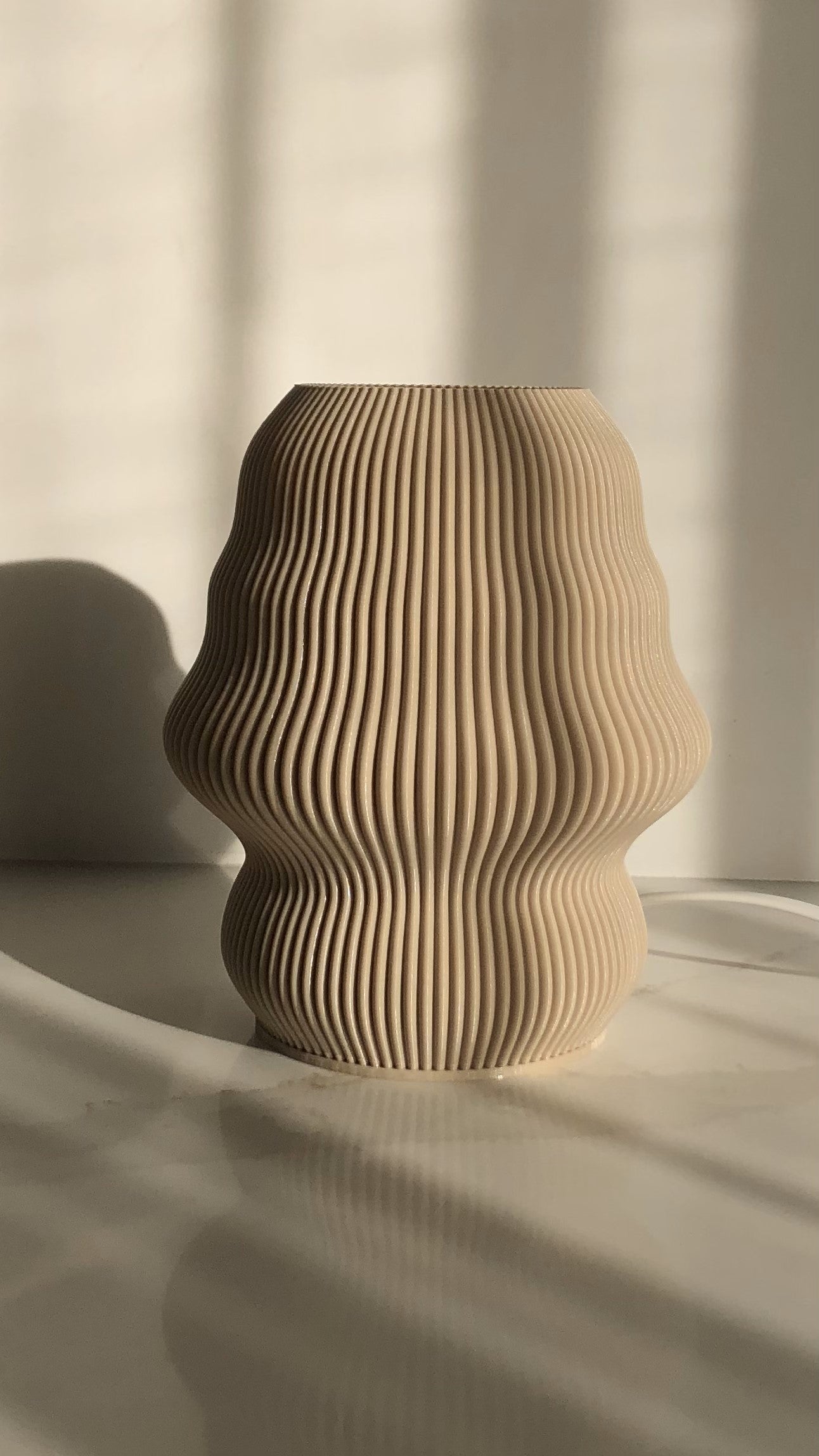 a wooden vase sitting on top of a white table
