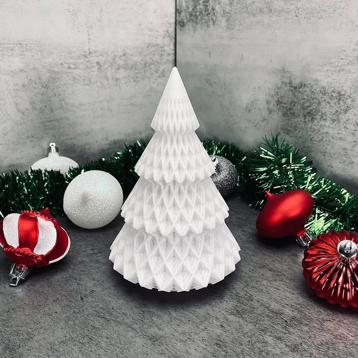 a white christmas tree surrounded by ornaments