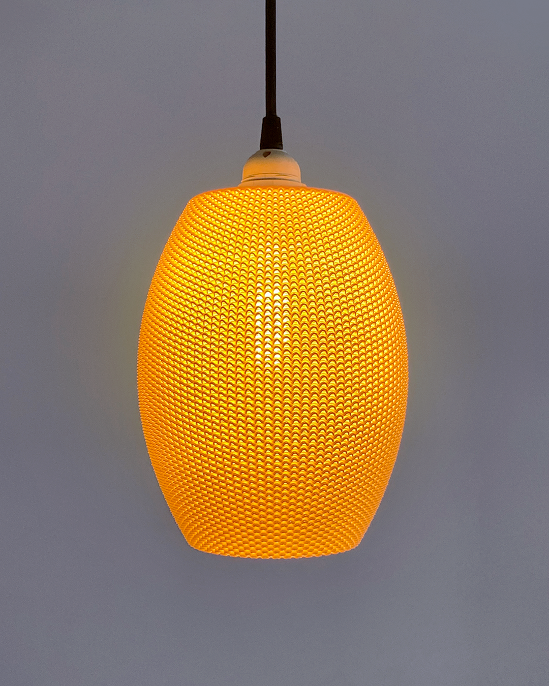 a yellow light hanging from a ceiling in a room