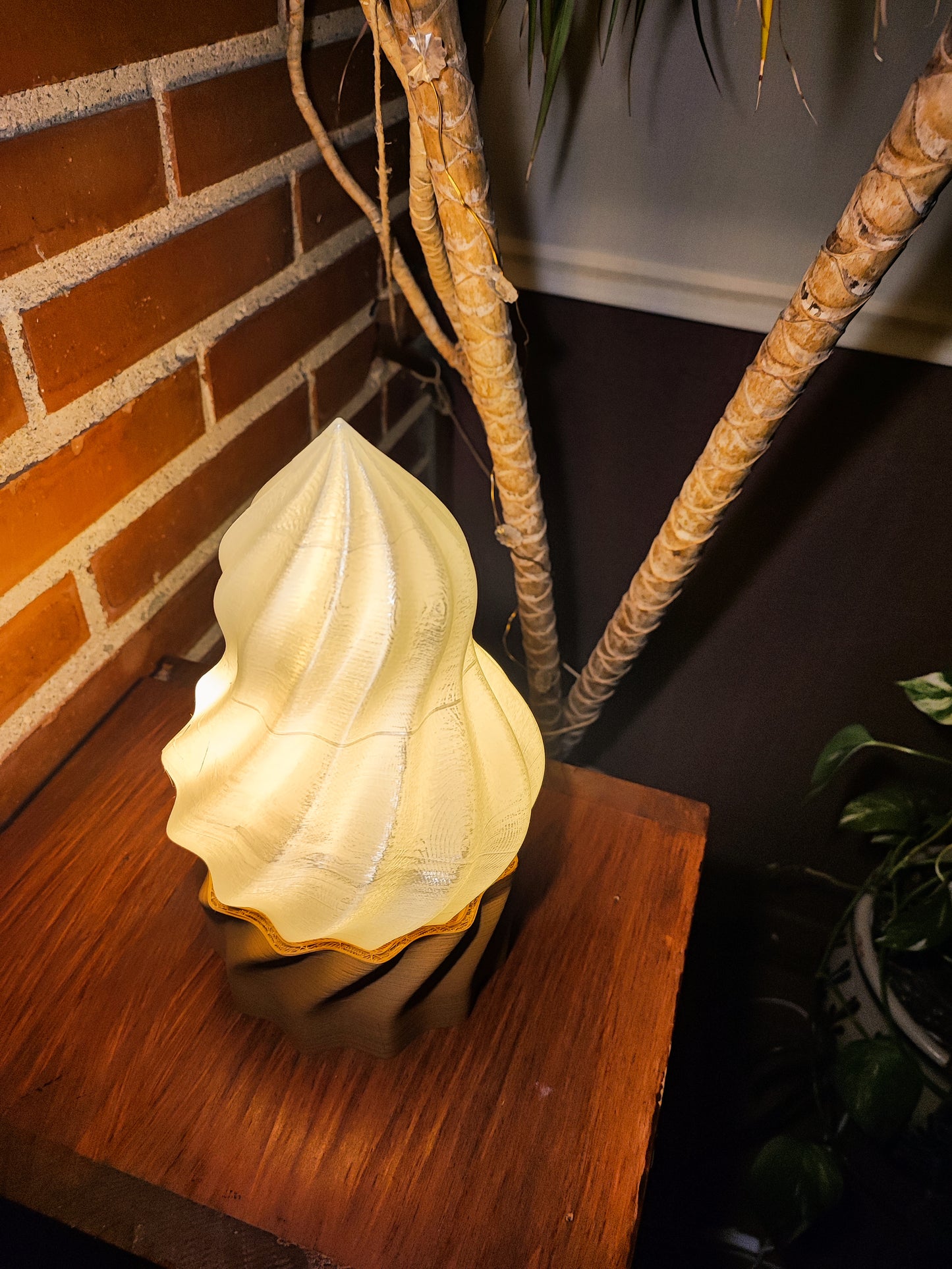 a yellow vase sitting on top of a wooden table