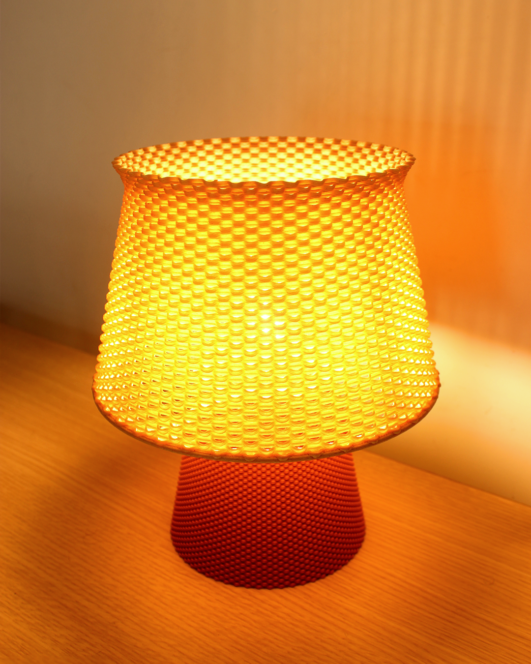 a yellow lamp sitting on top of a wooden table