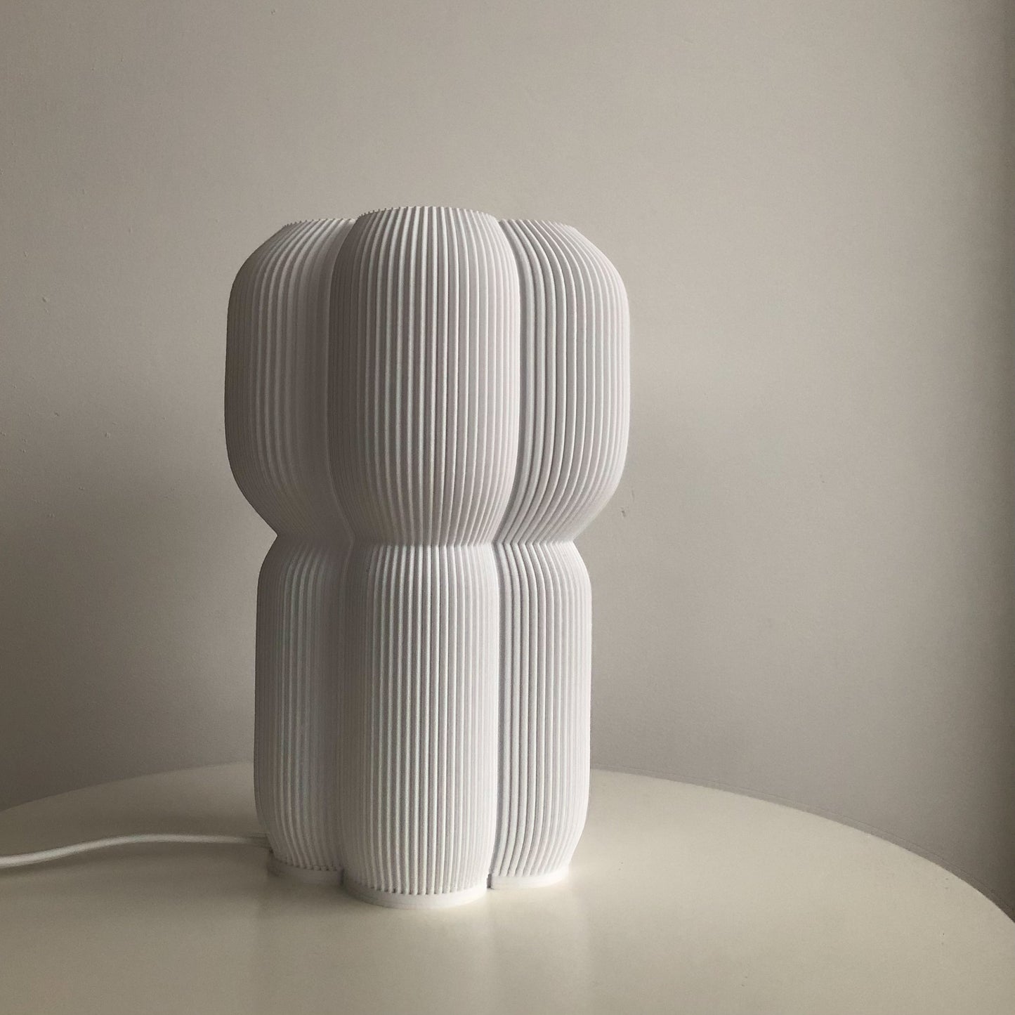 a white sculpture sitting on top of a white table