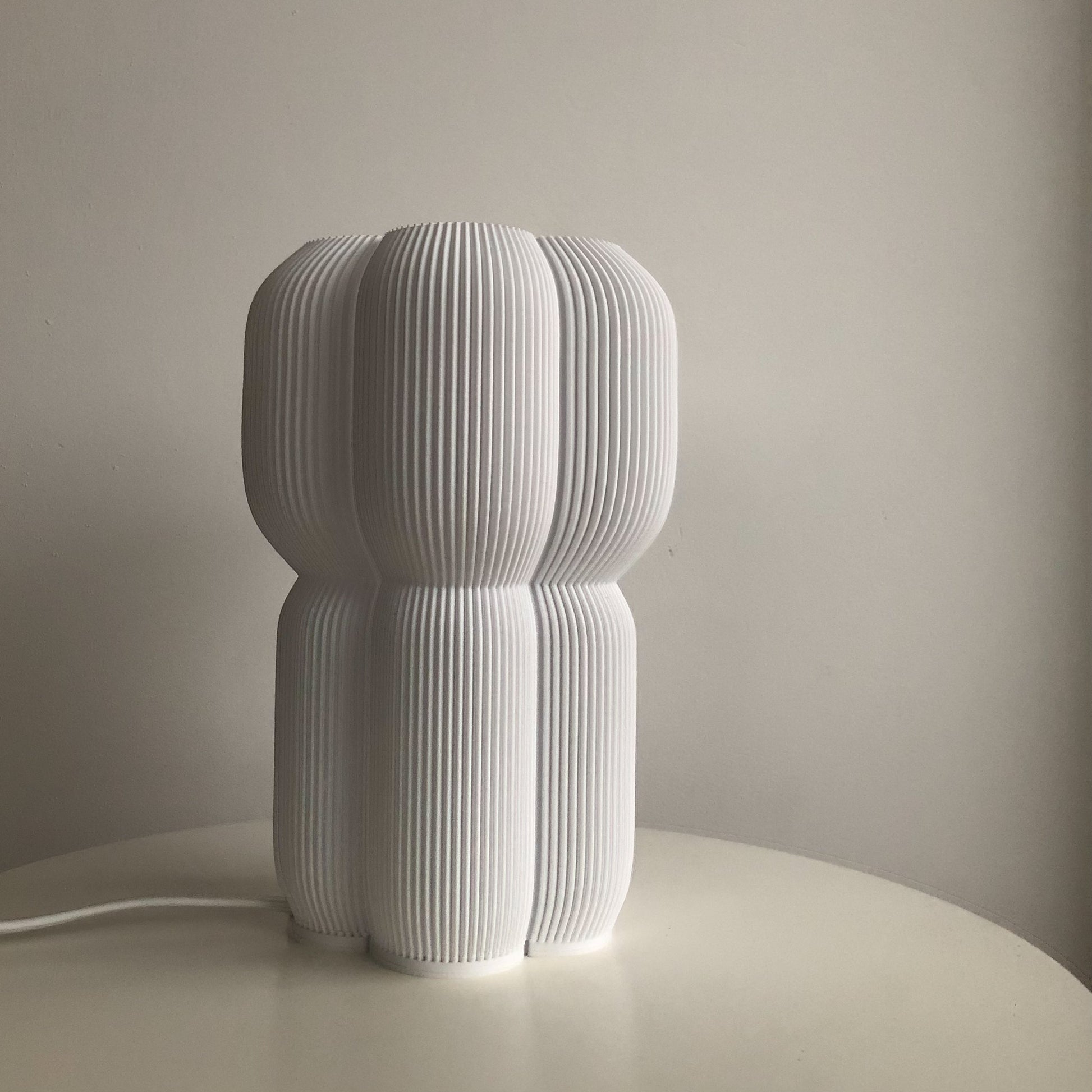 a white sculpture sitting on top of a white table