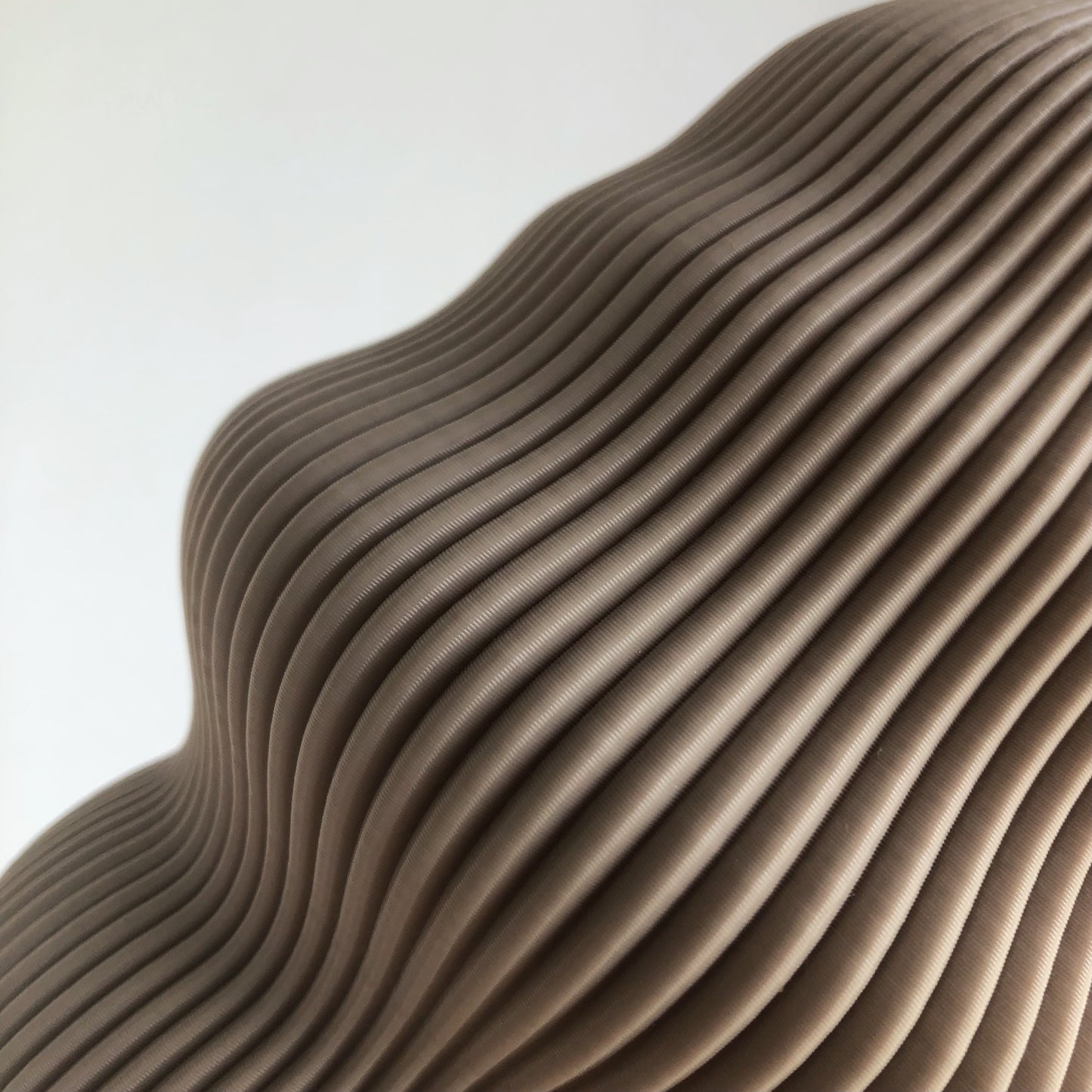 a close up of a sculpture made of wavy material