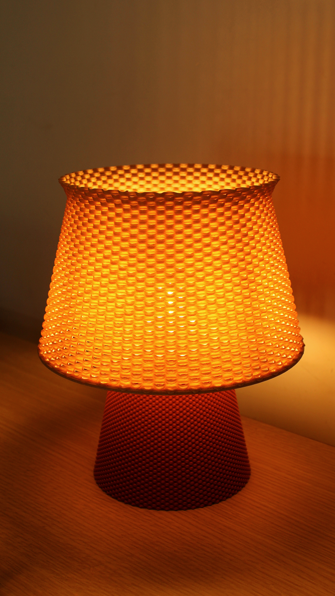 a yellow lamp sitting on top of a wooden table