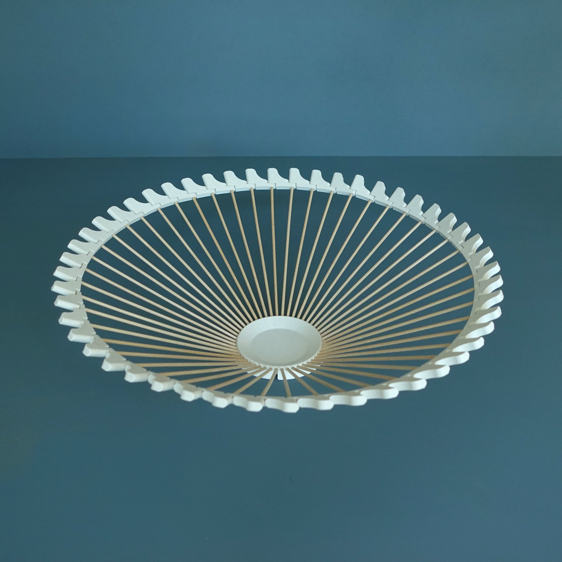 a white ceiling fan on a blue wall