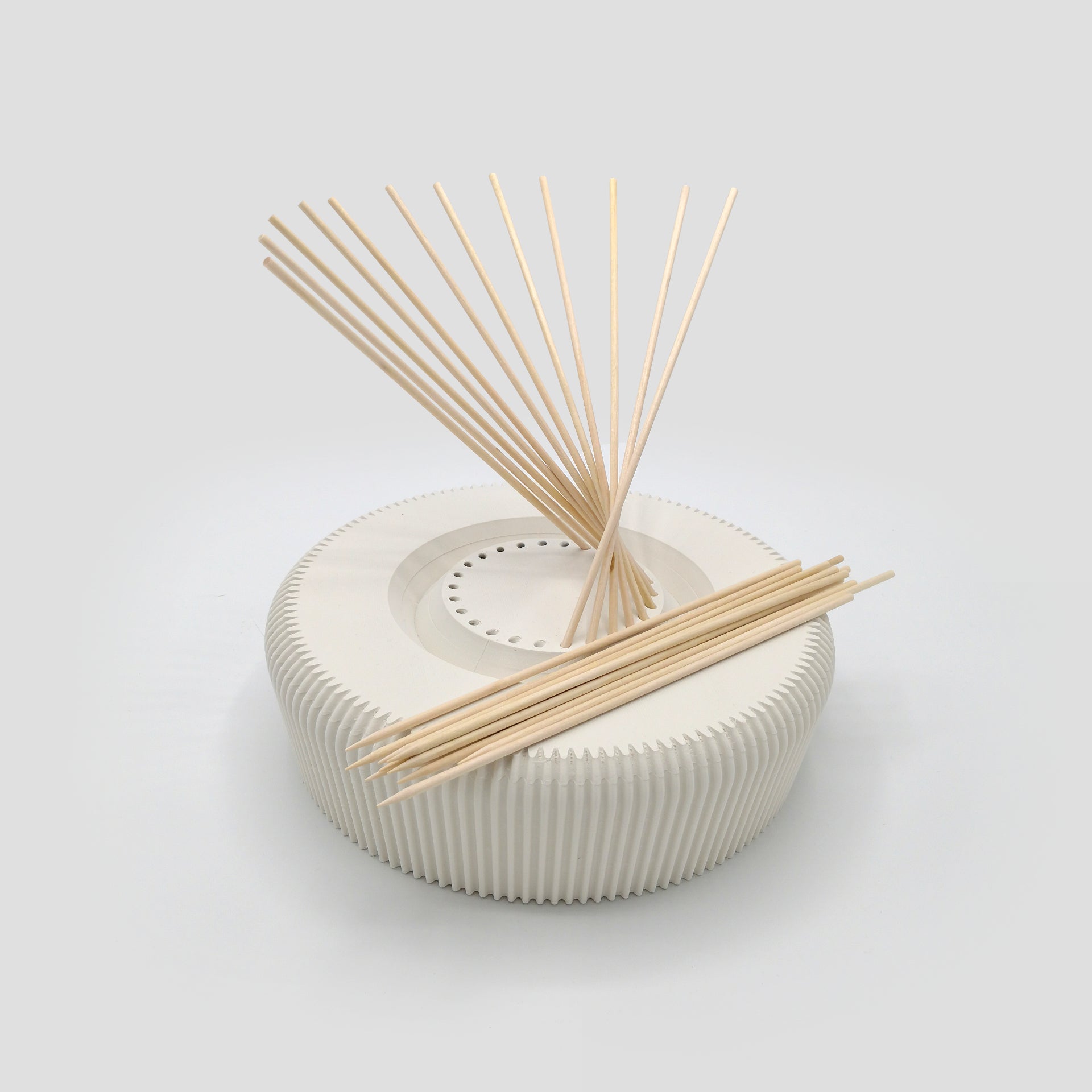 a white container with sticks sticking out of it