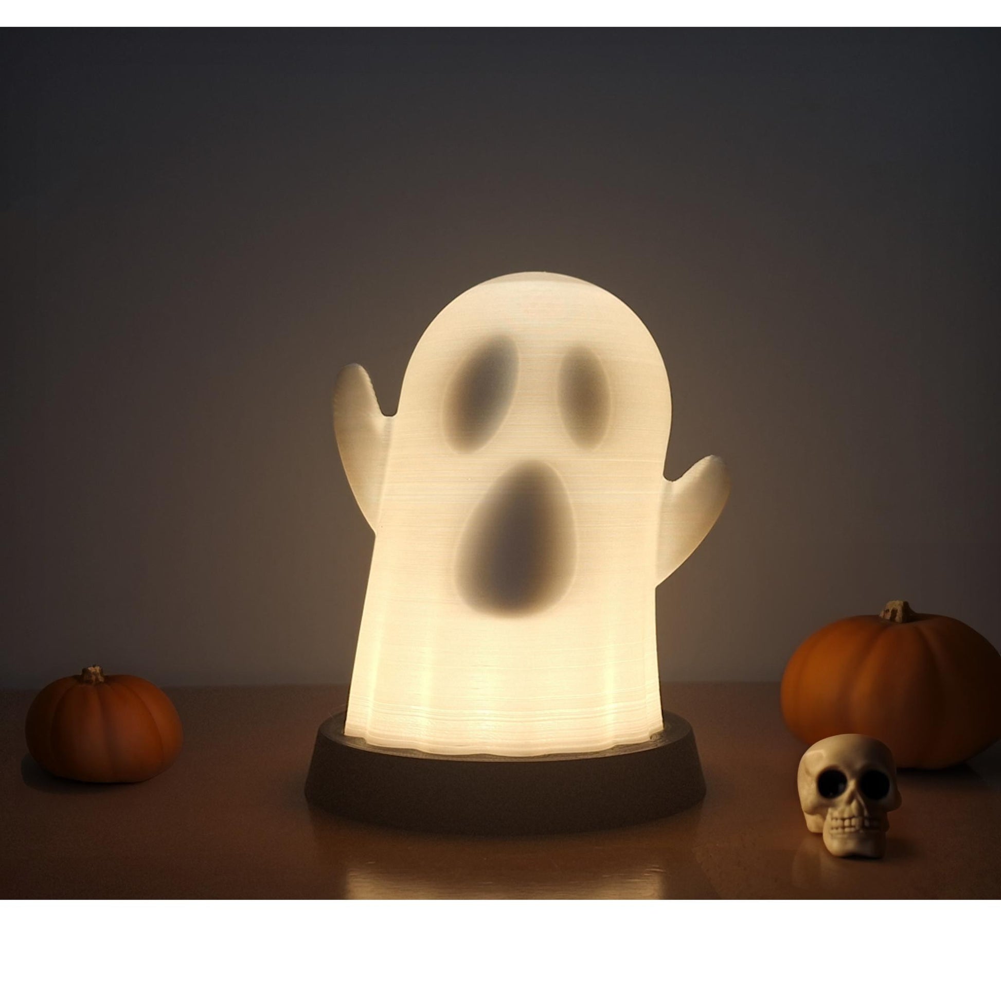 a light up ghost with a skull on a table