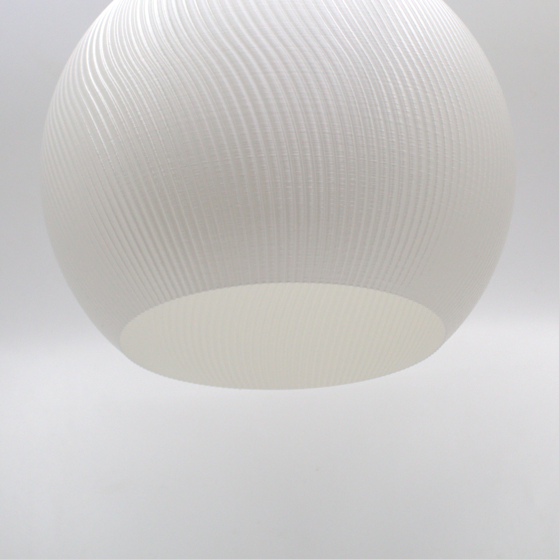 a white light hanging from a ceiling in a room