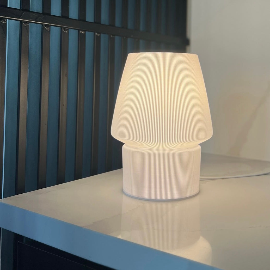 a white lamp sitting on top of a table