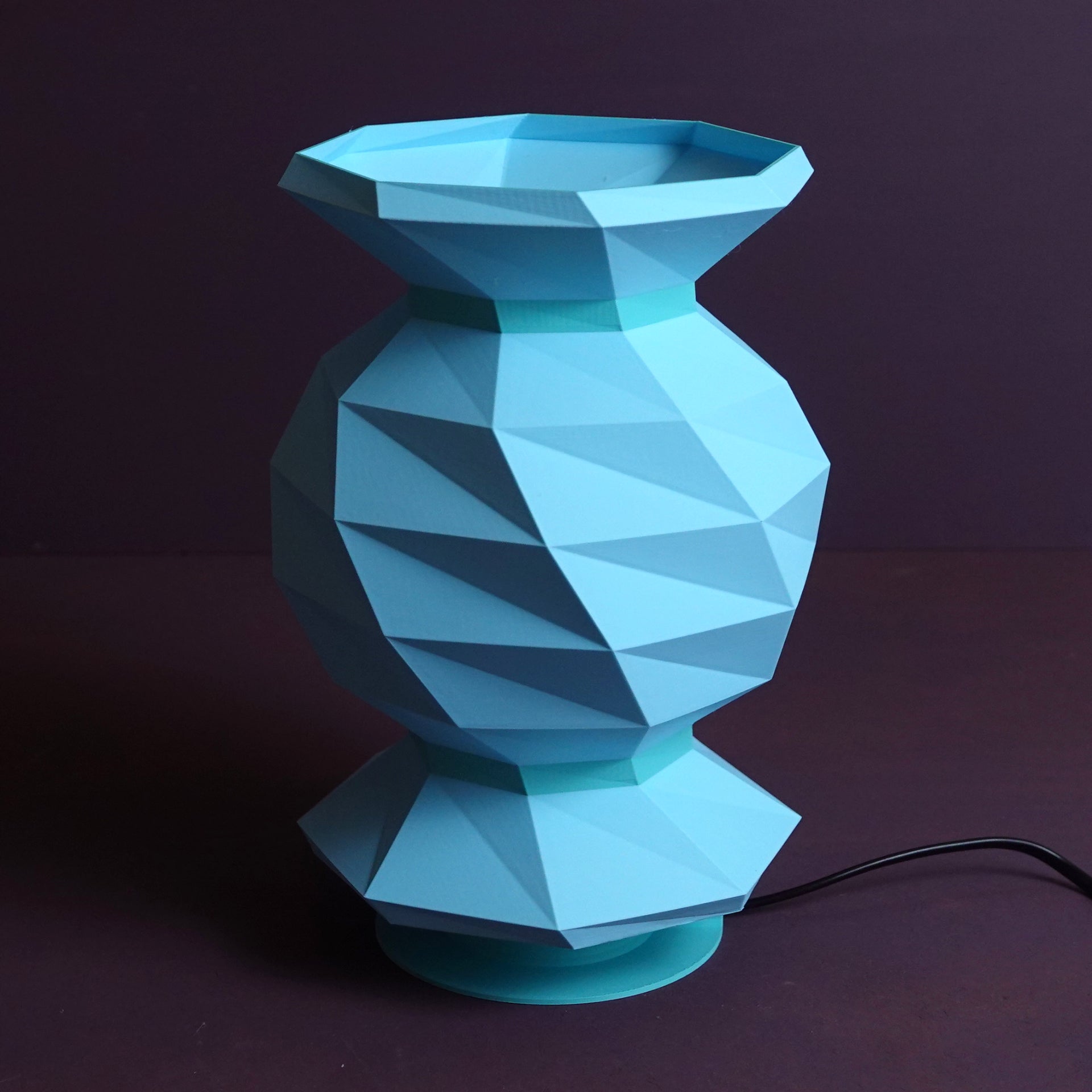a blue vase sitting on top of a table