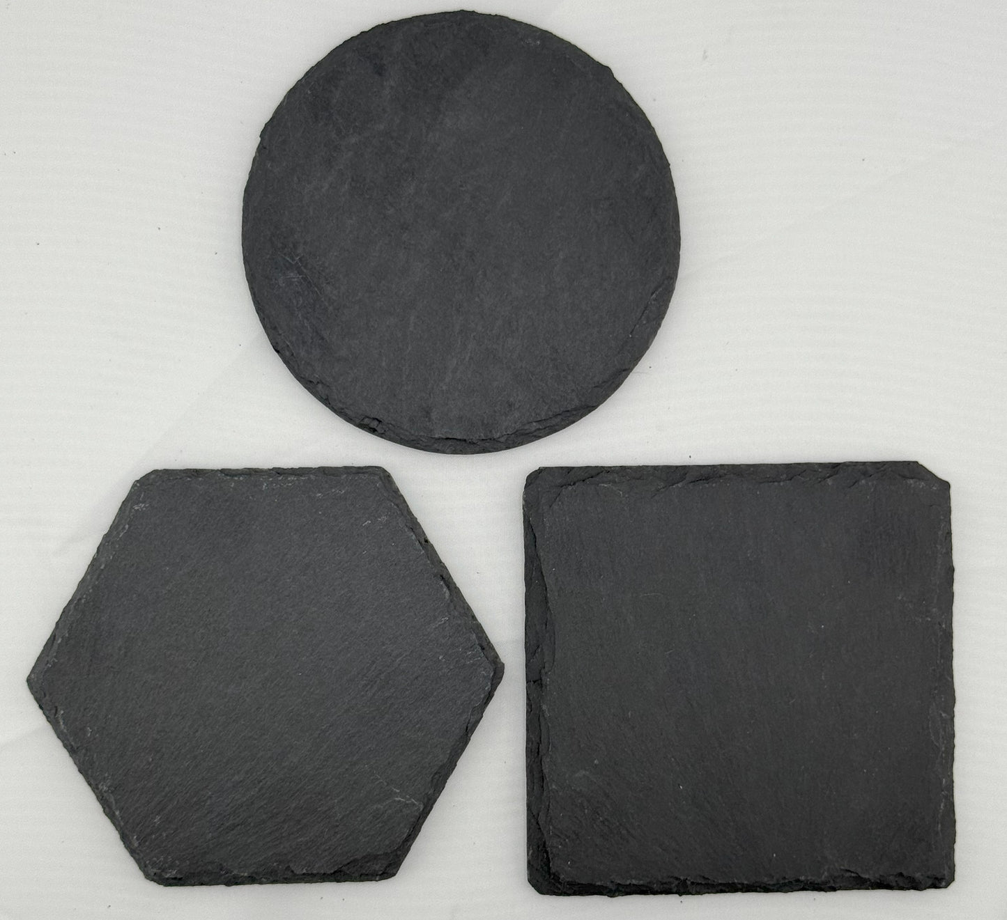 three pieces of slate sitting next to each other