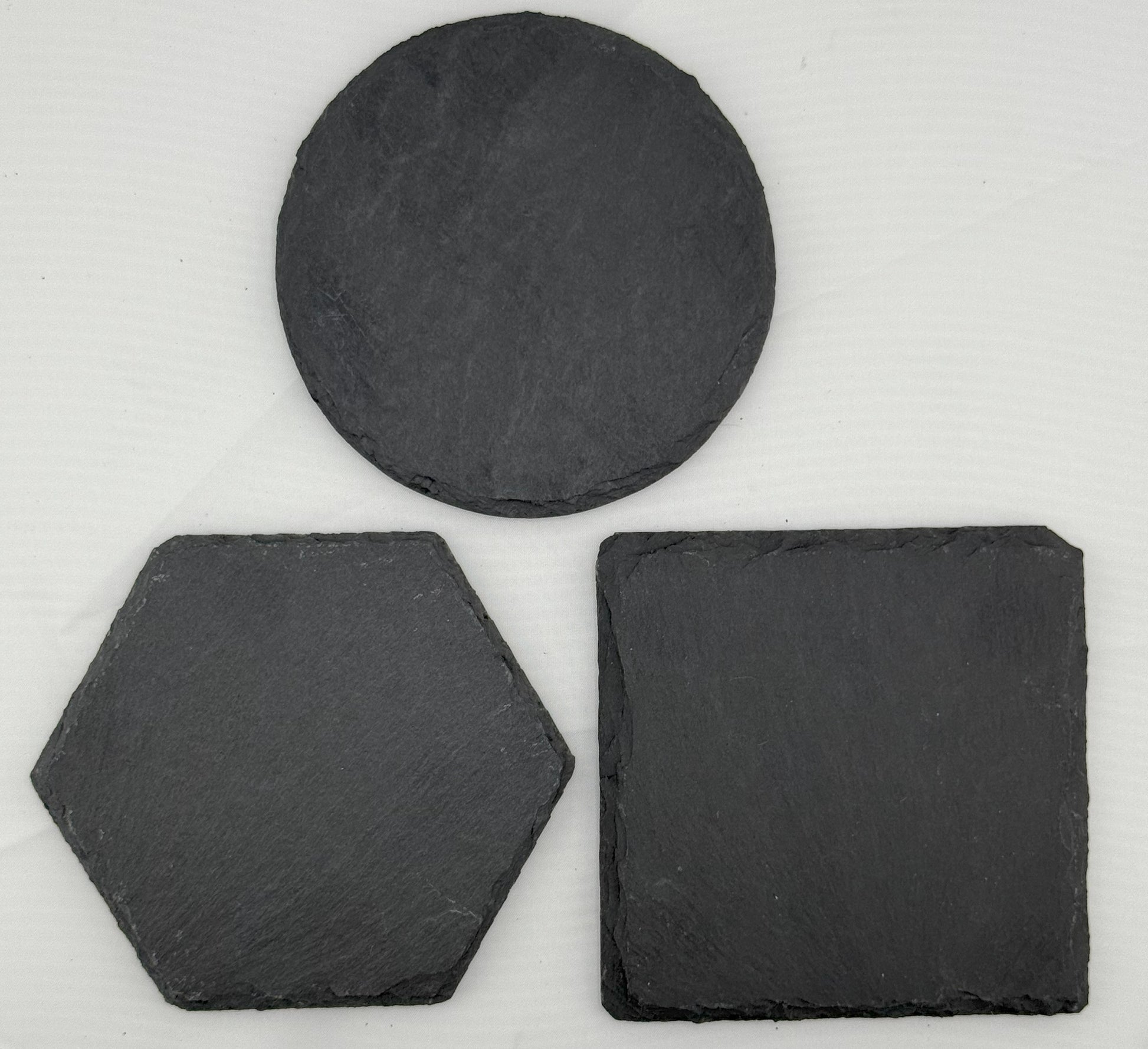 three pieces of slate sitting next to each other