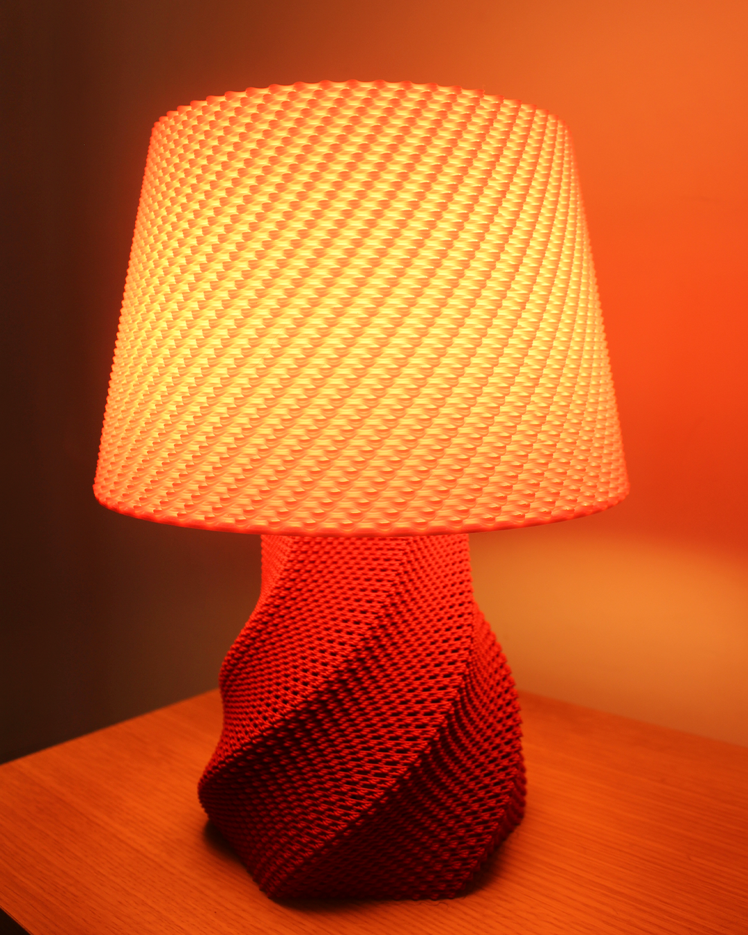 a red lamp sitting on top of a wooden table