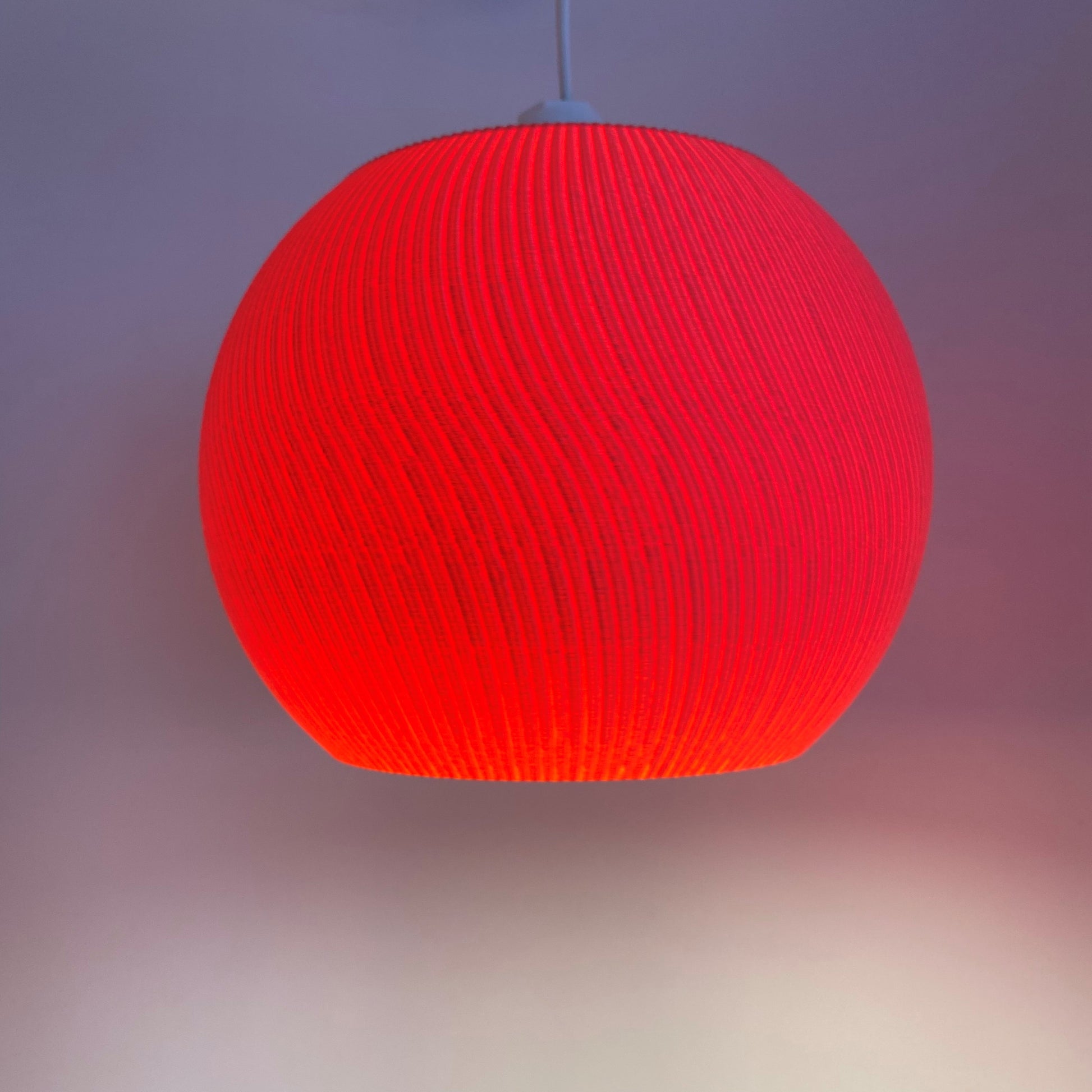 a red light hanging from a ceiling in a room
