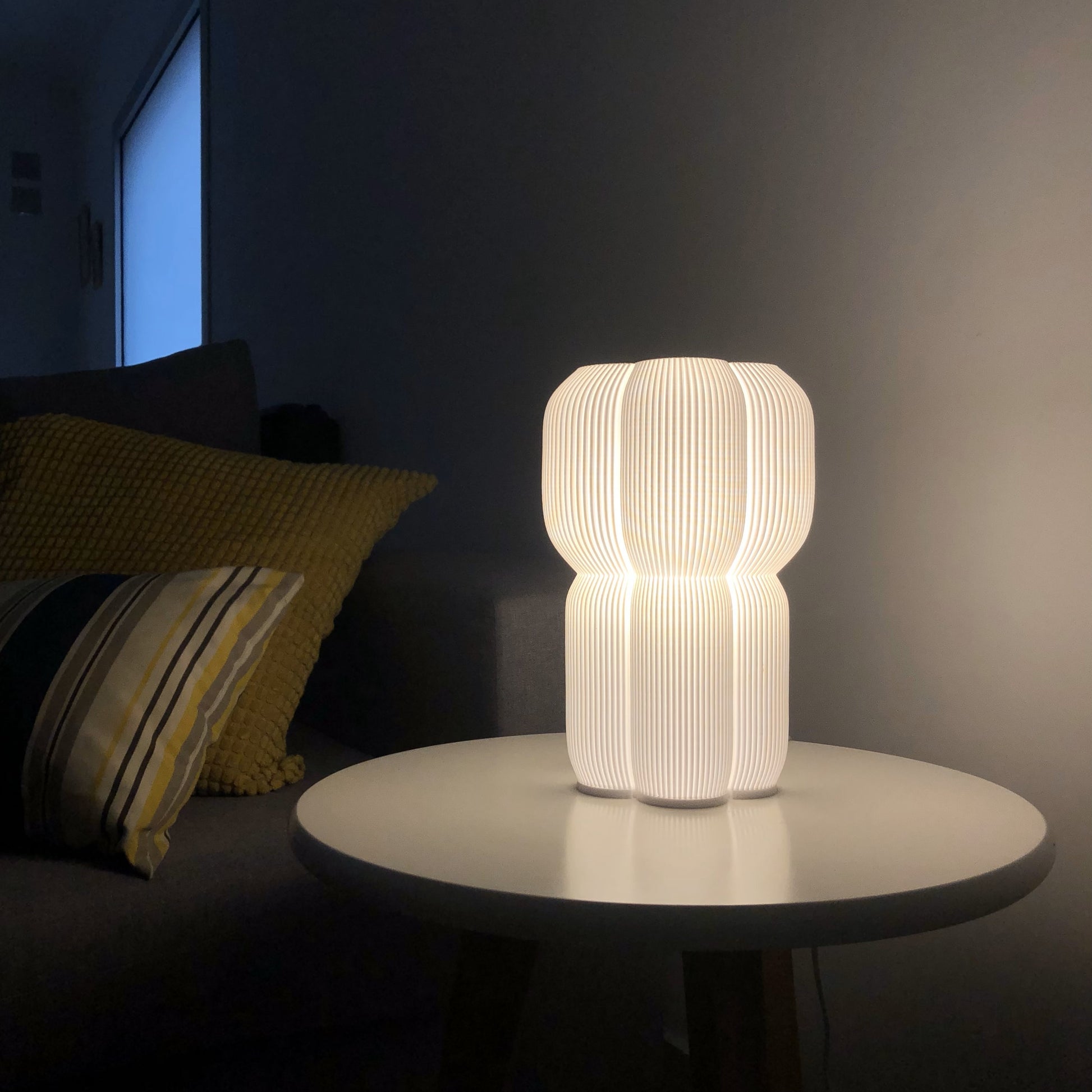 a white lamp sitting on top of a table