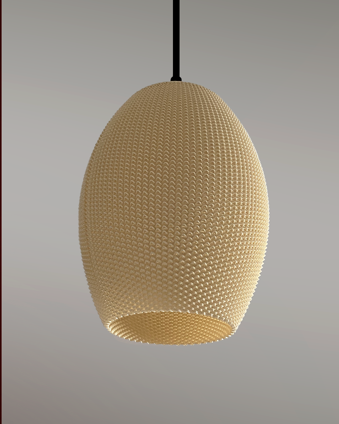 a white ball hanging from a black cord