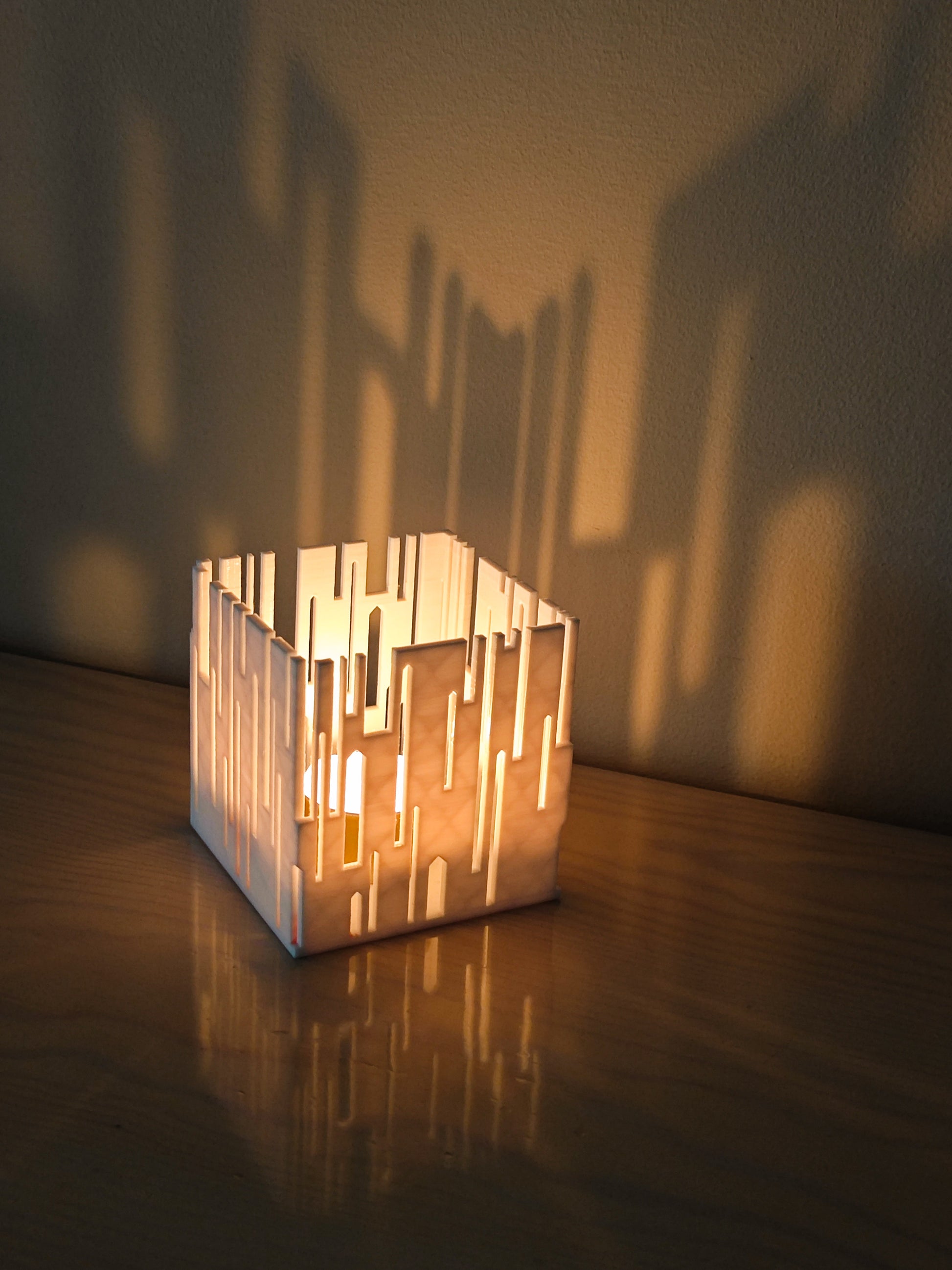 a candle holder sitting on top of a wooden table