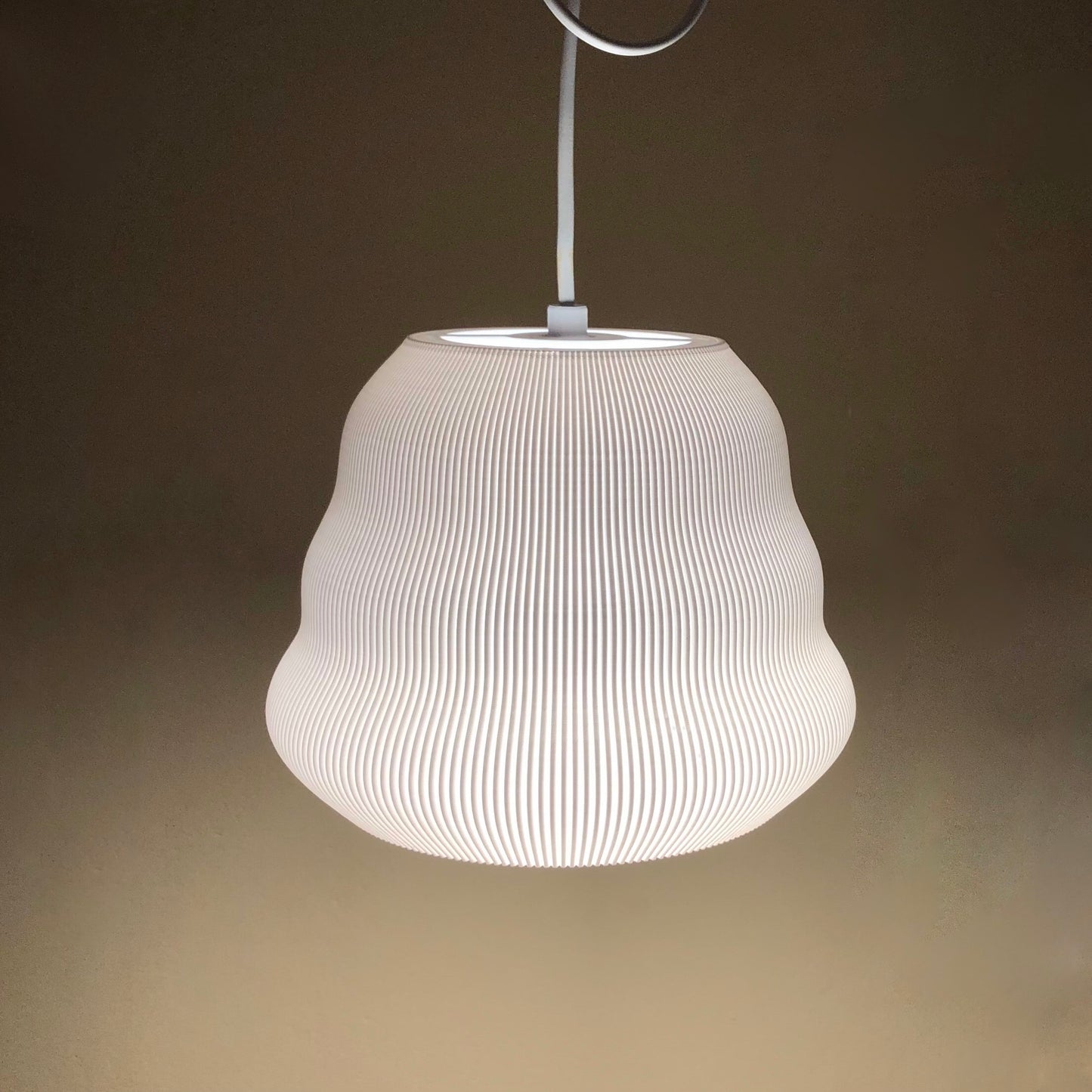 a white lamp hanging from a ceiling in a room