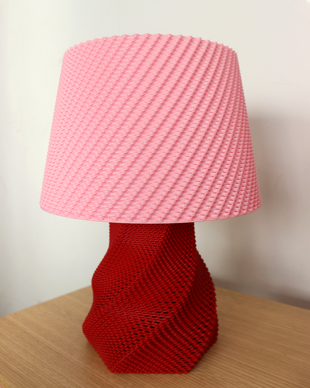 a red lamp sitting on top of a wooden table