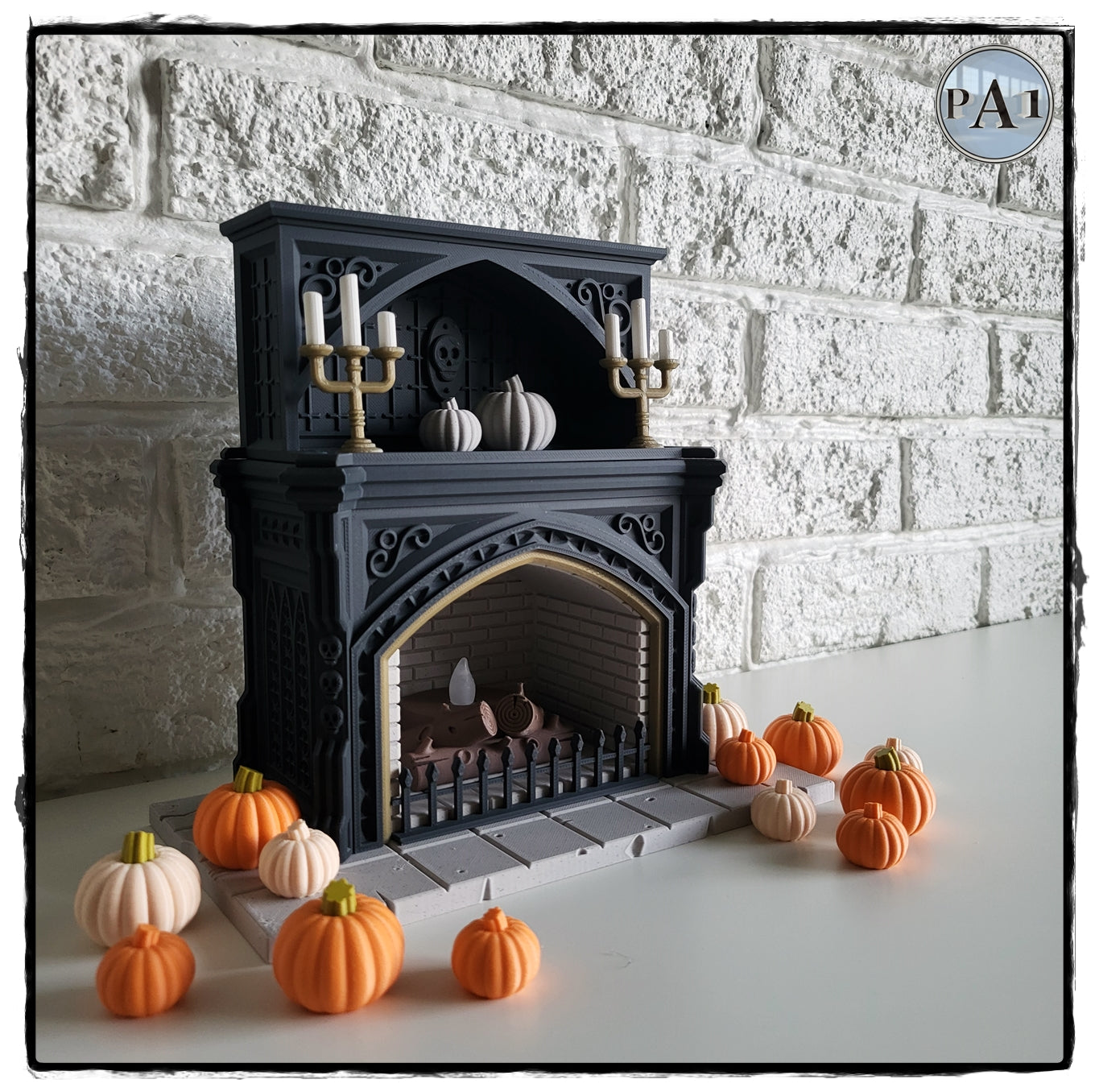 a miniature fireplace with a black exterior and gold accents, surrounded by a collection of small orange pumpkins.