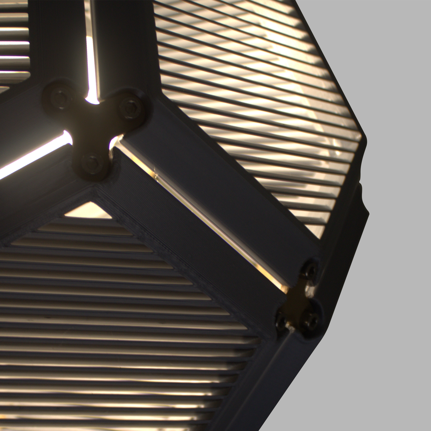 a close up of a metal structure with a light coming from it