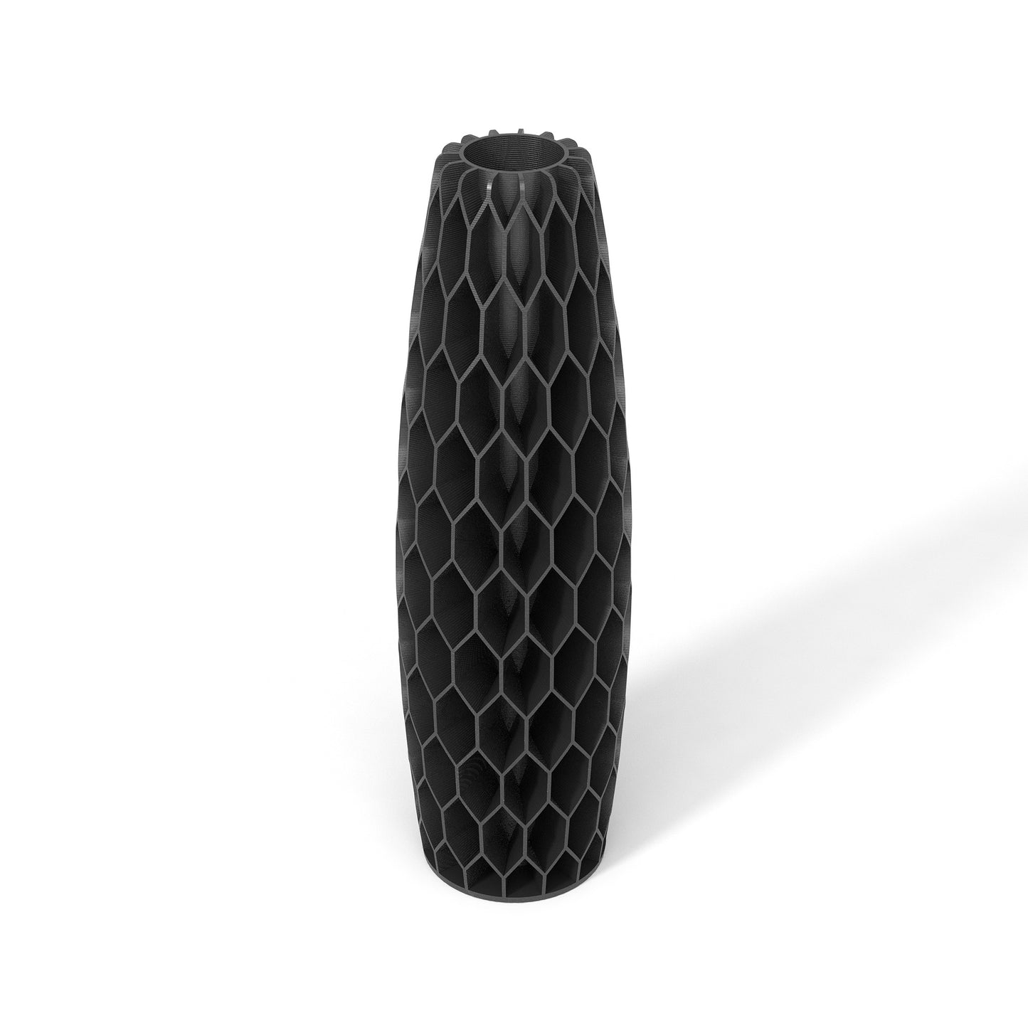 a black vase sitting on top of a white table