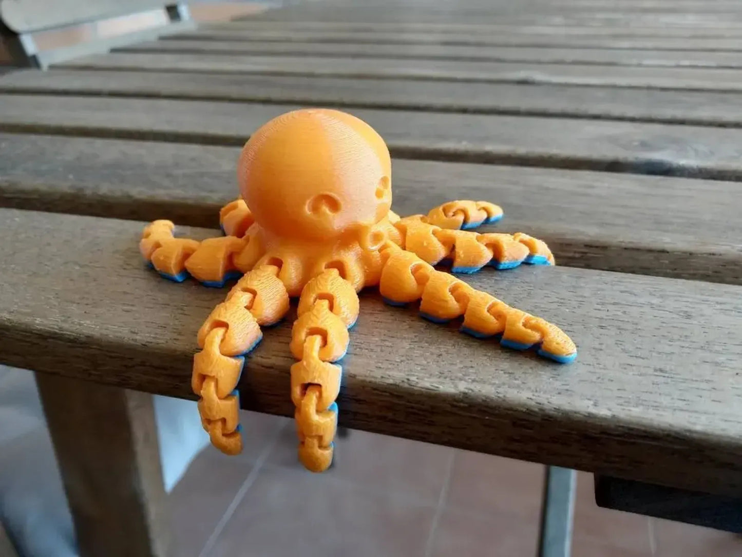 a toy octopus sitting on top of a wooden table