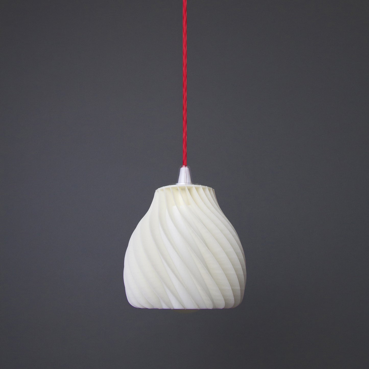 a white light bulb hanging from a red cord