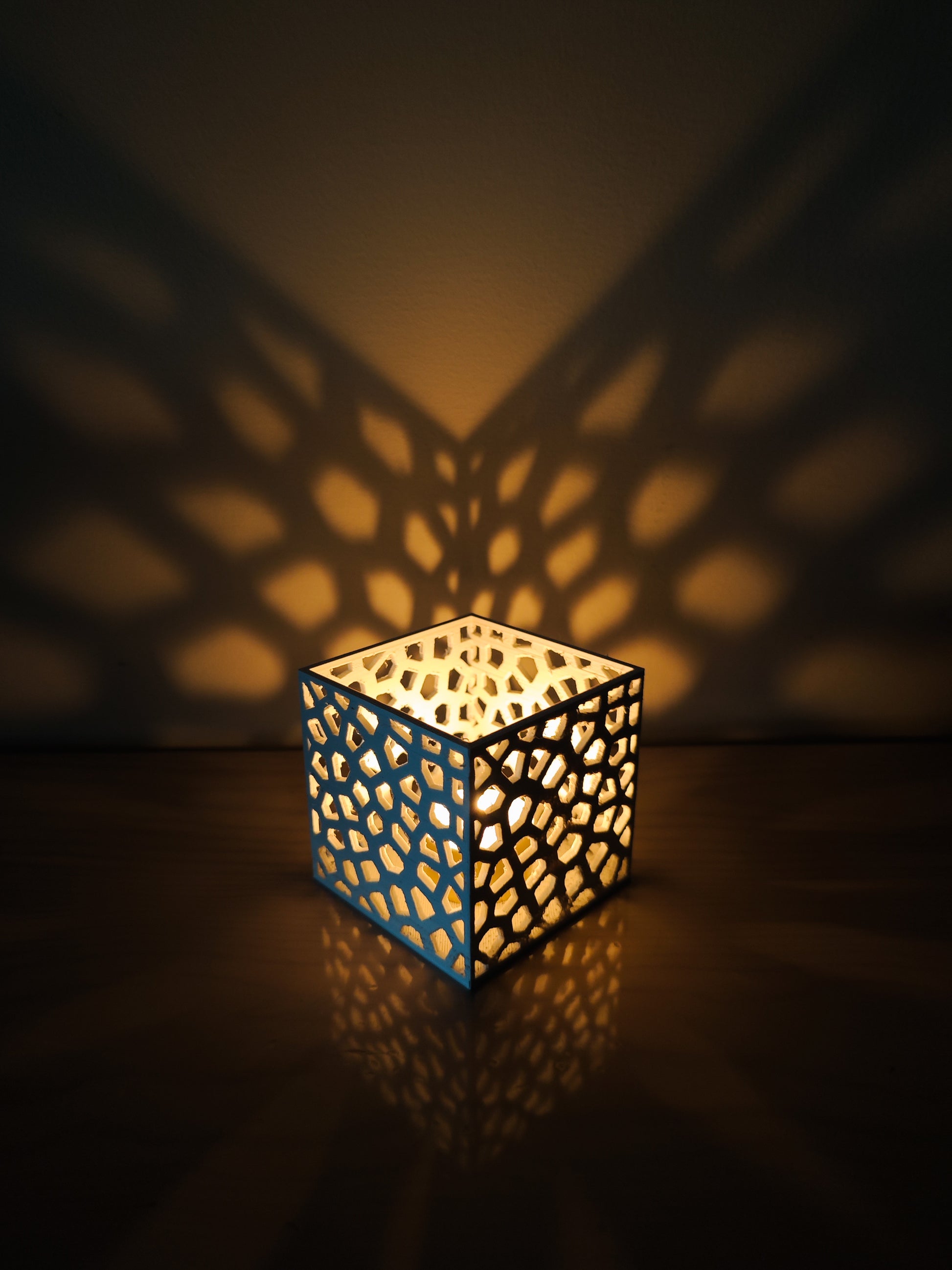 a lit candle that is sitting on a table