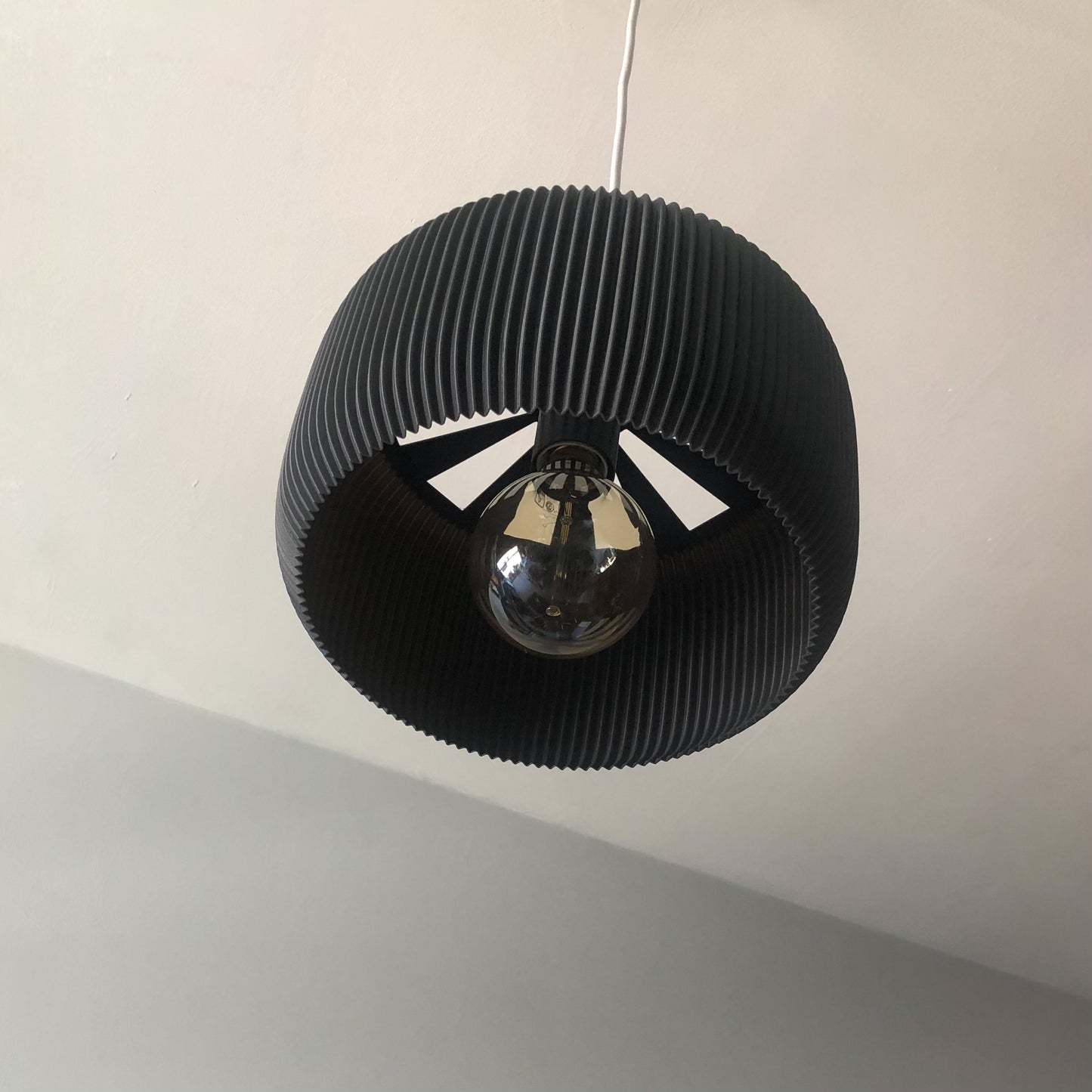 a black light fixture hanging from a ceiling