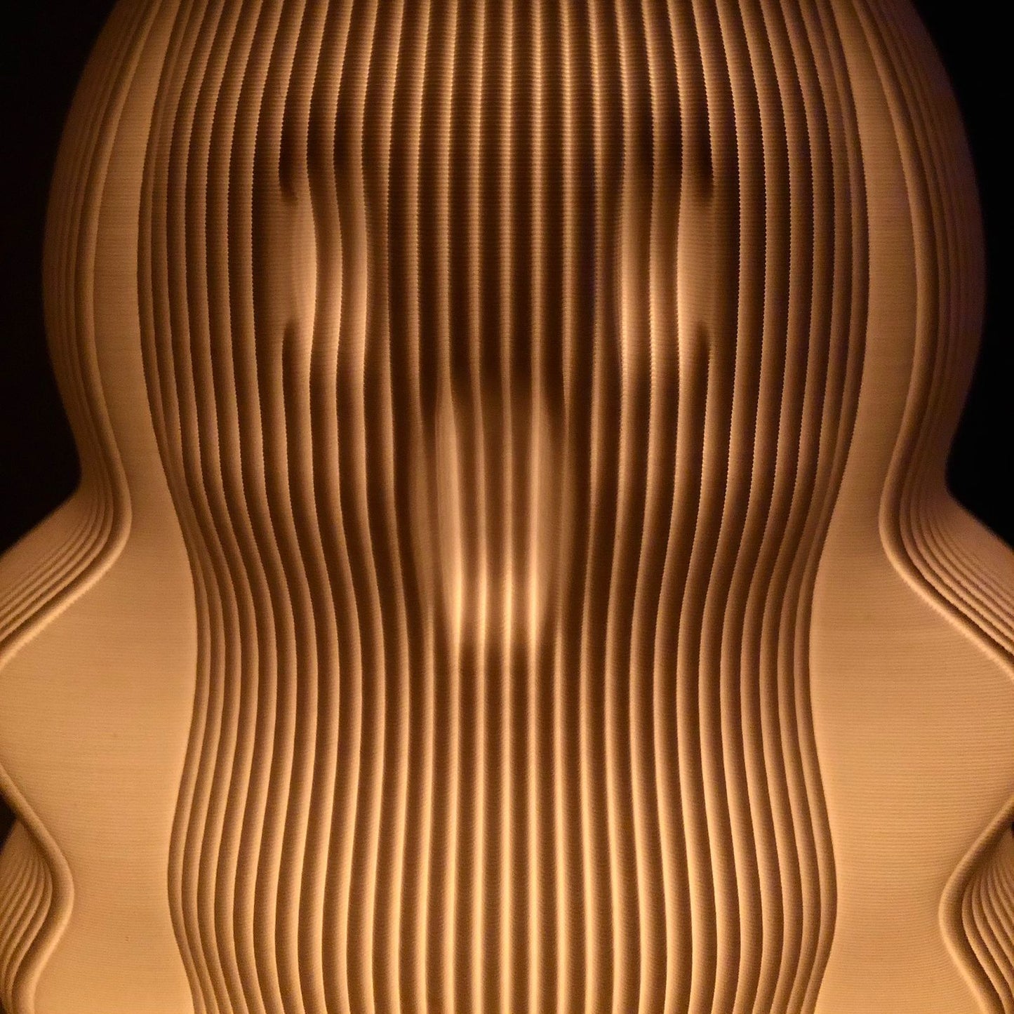 a close up of a wooden object with a black background