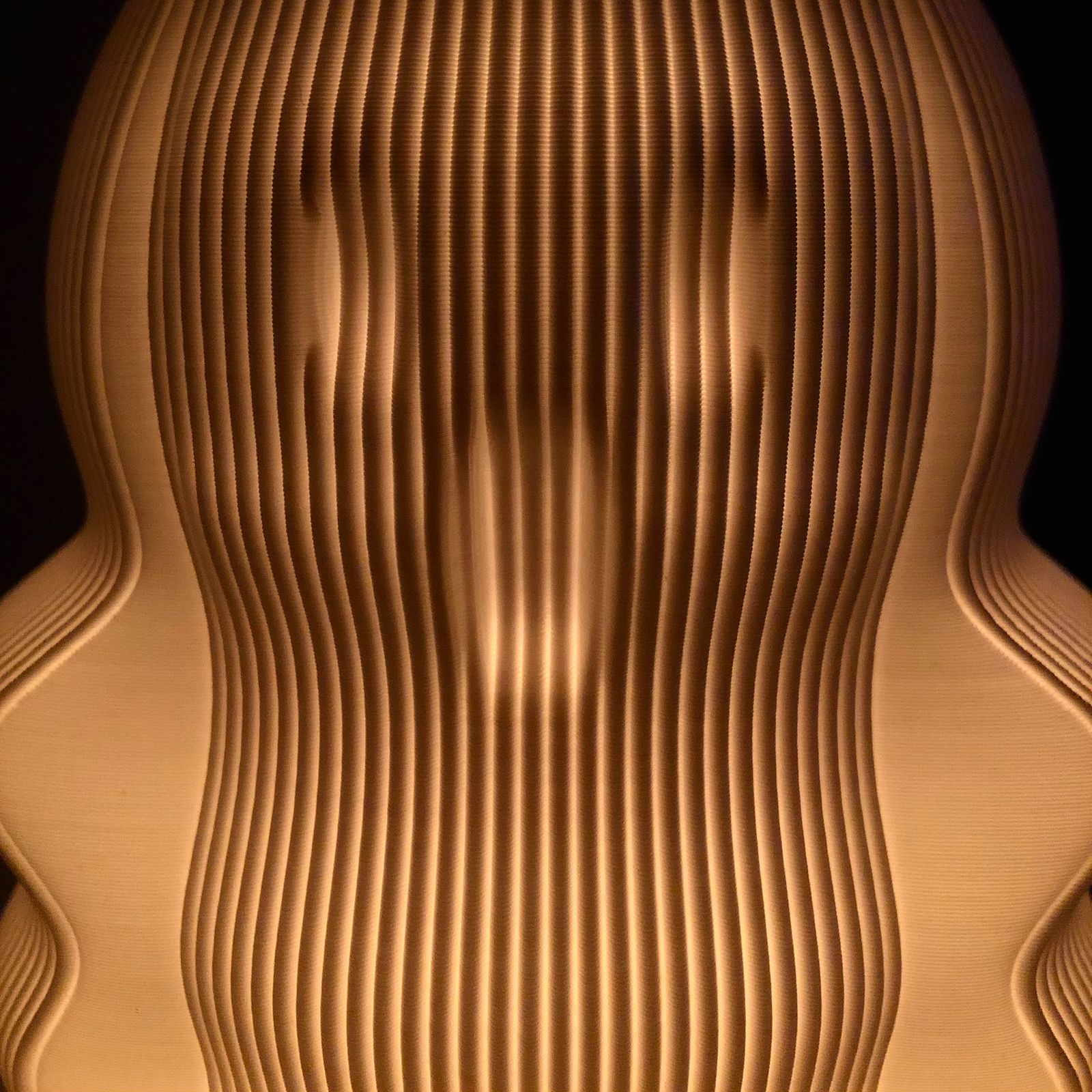 a close up of a wooden object with a black background