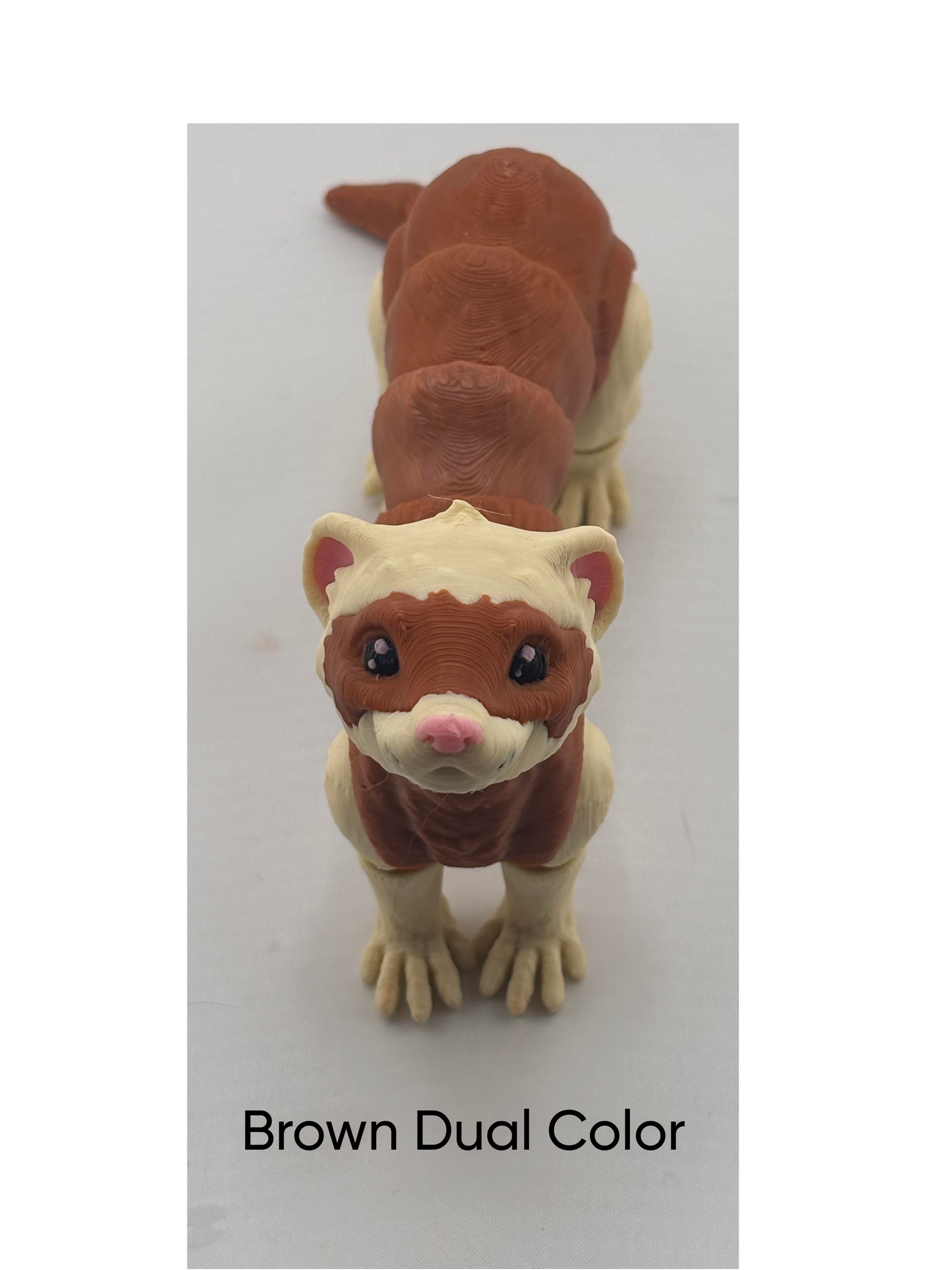 a brown and white toy animal on a white surface